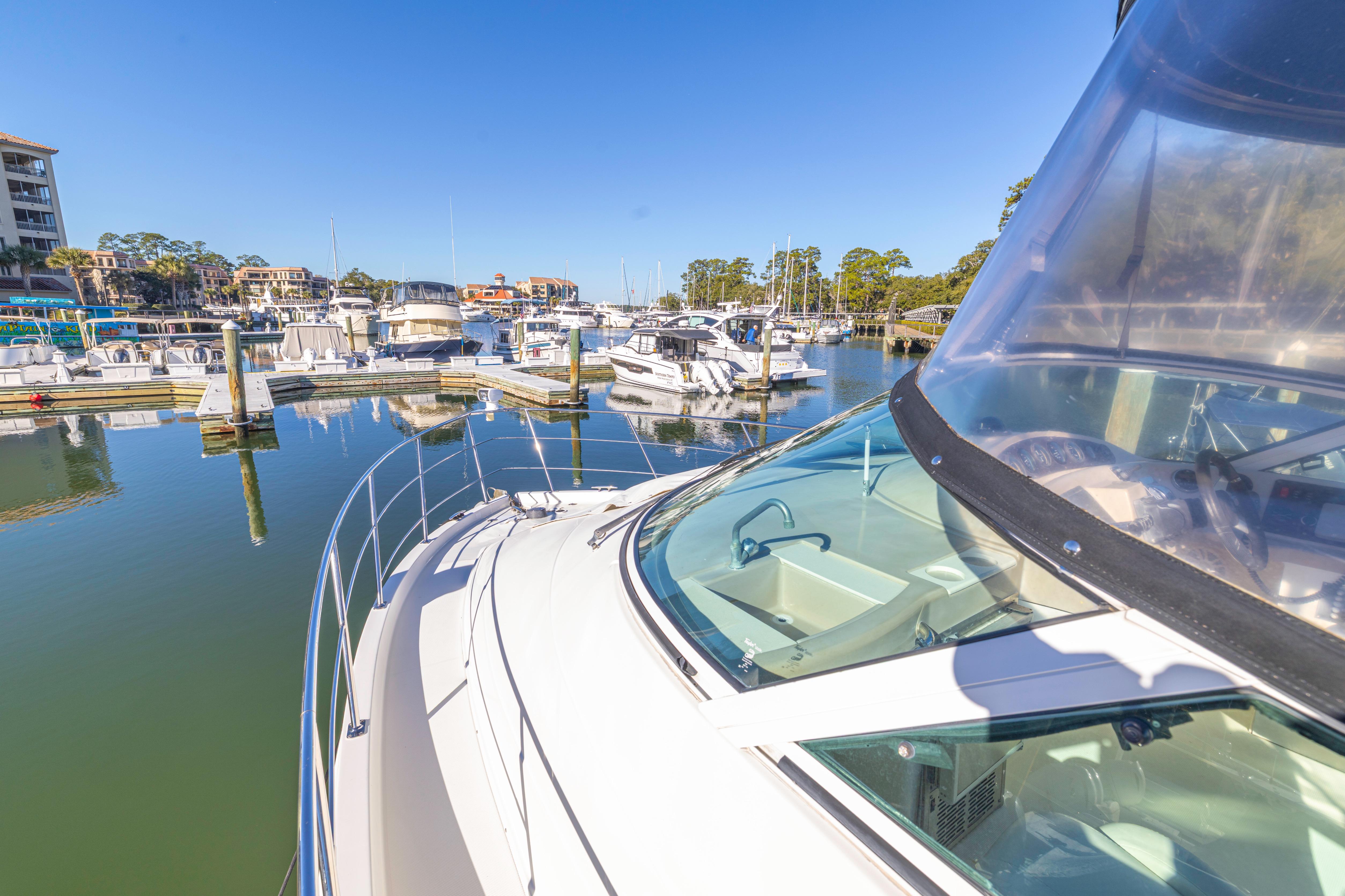 2006 Carver 36 Mariner yacht docked in a sunny marina.