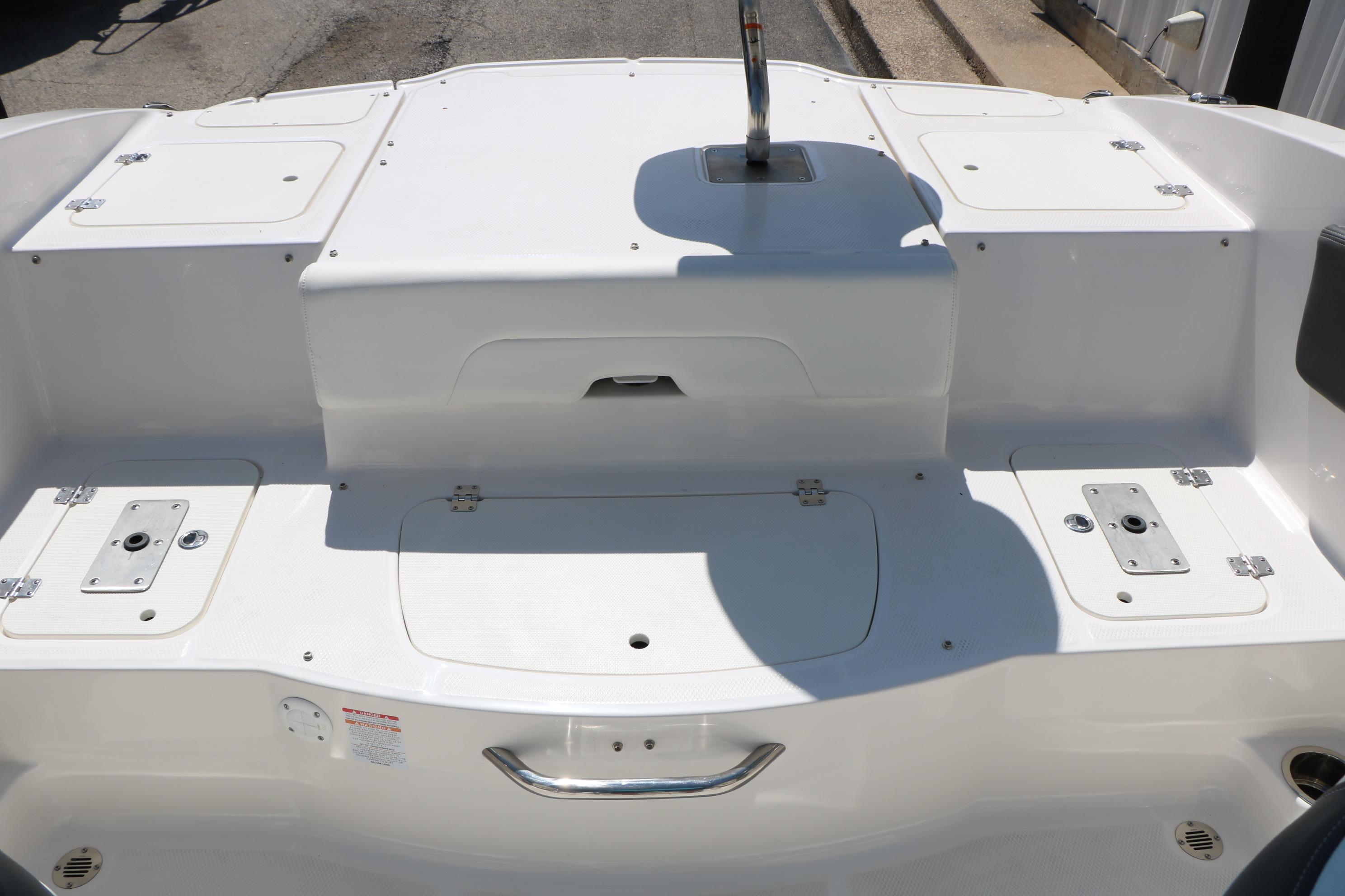 2025 Chaparral 21 SSi Ski & Fish boat deck with storage compartments.