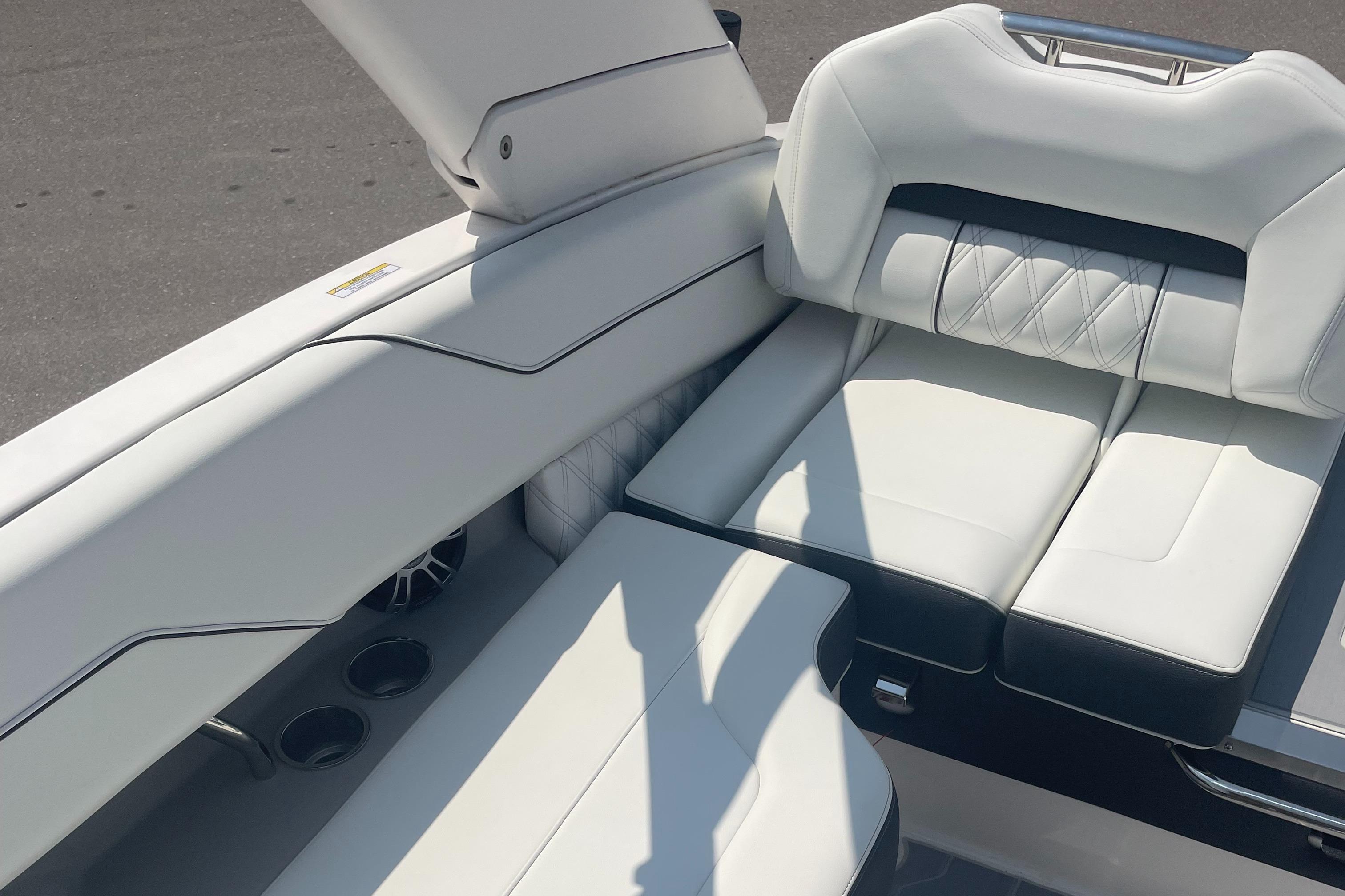 2025 Regal LS4 Surf boat interior with white leather seating and cup holders.