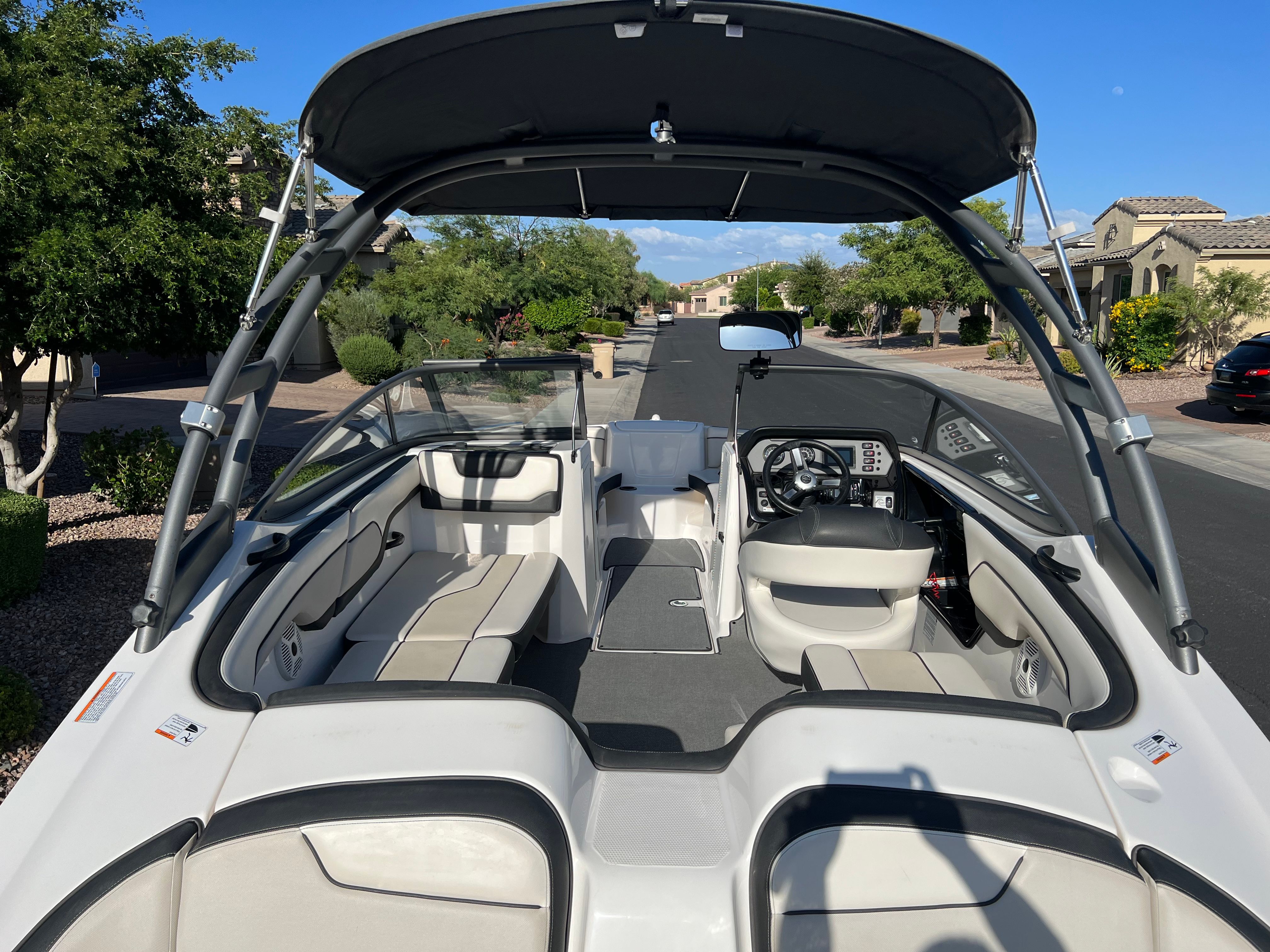 2018 Yamaha AR210 parked on a street. It features an open cockpit and a Bimini top.