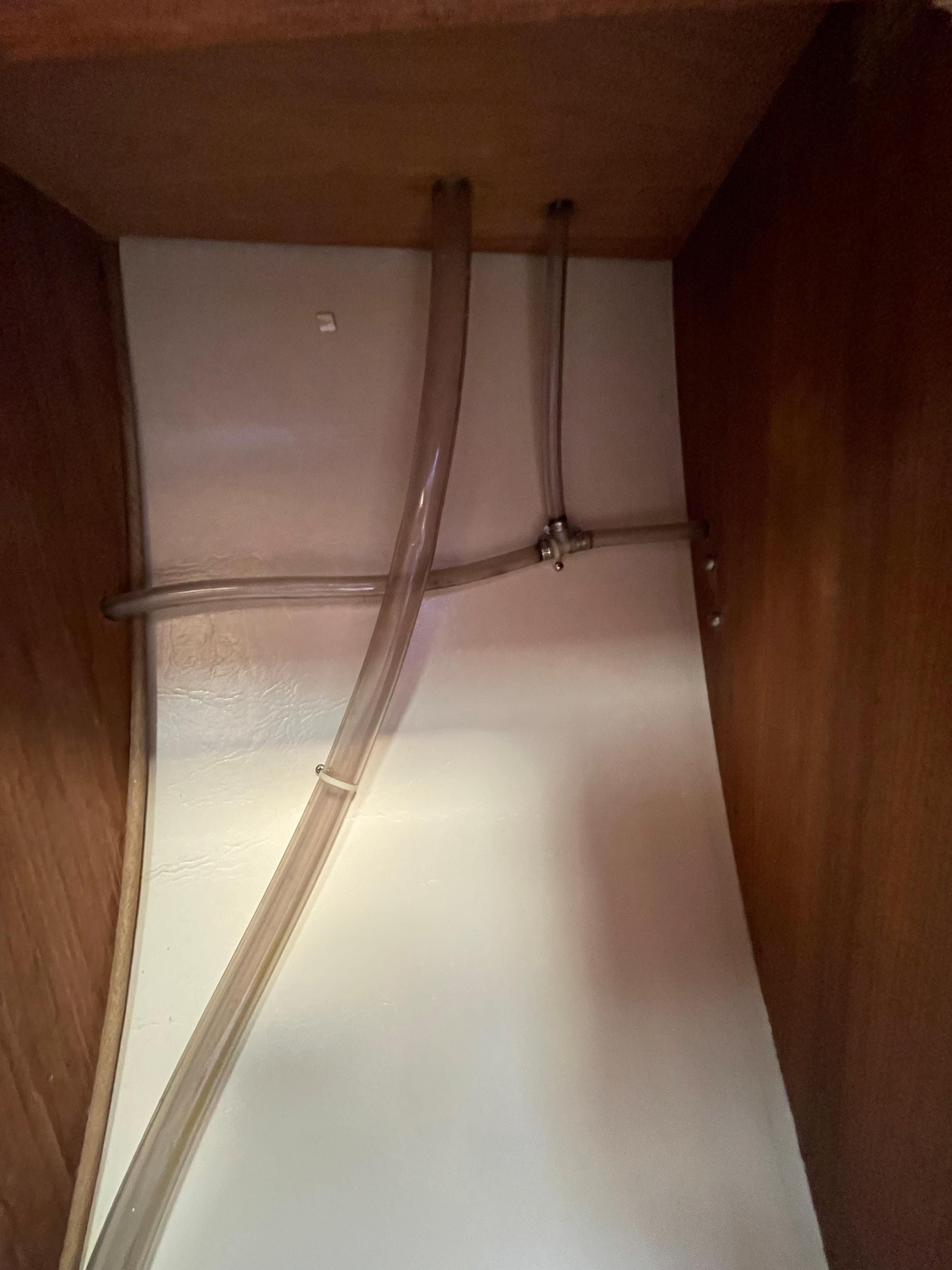 Interior of a 1984 Catalina 30 with hoses.
