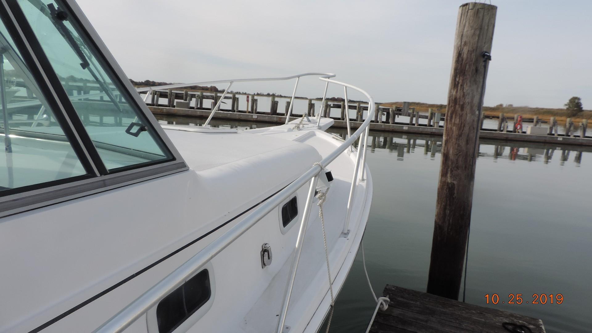 1998 Mainship 30 PILOT boat docked at a marina, side view.