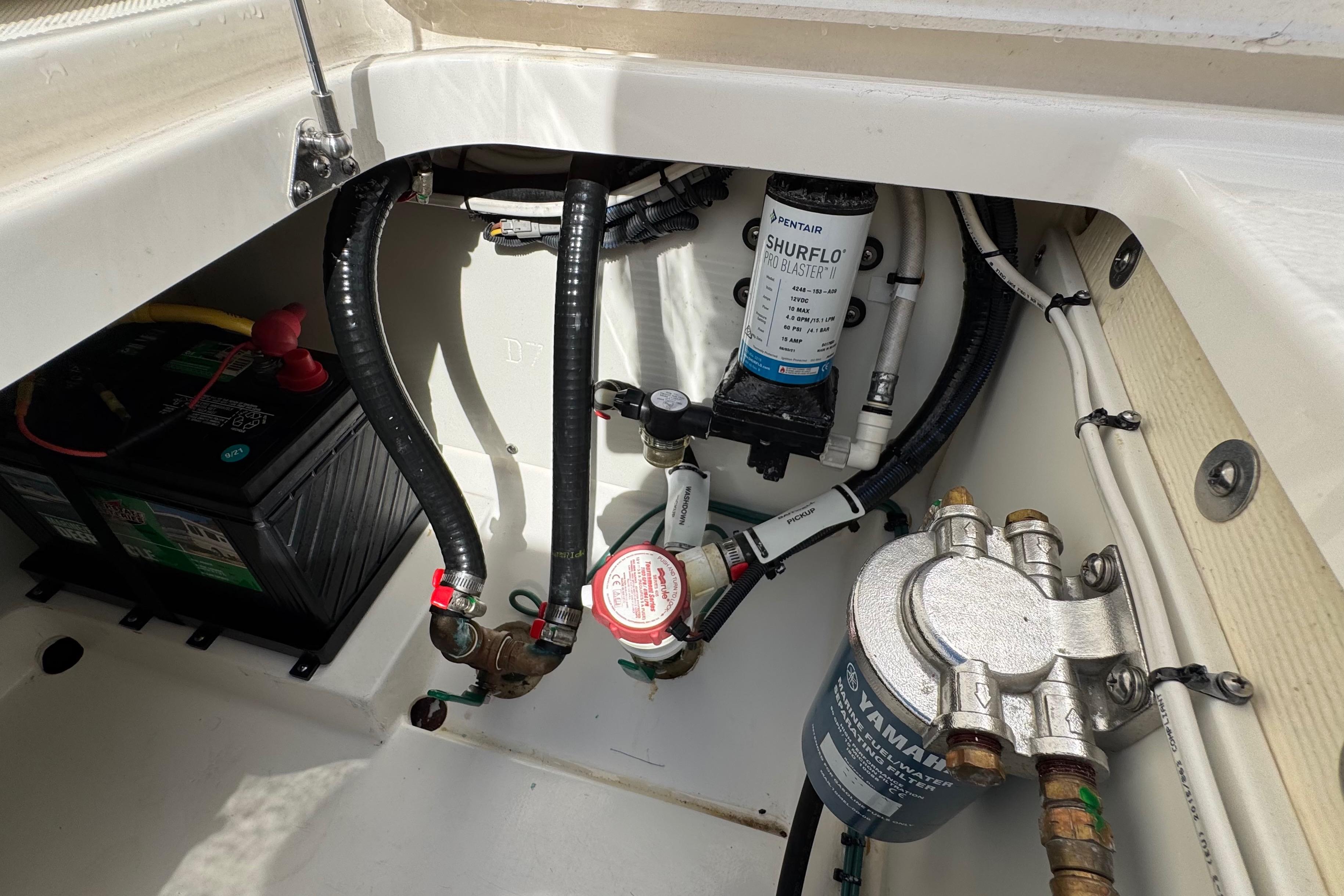 2022 Pursuit DC 266 Dual Console boat compartment with battery and pump system.