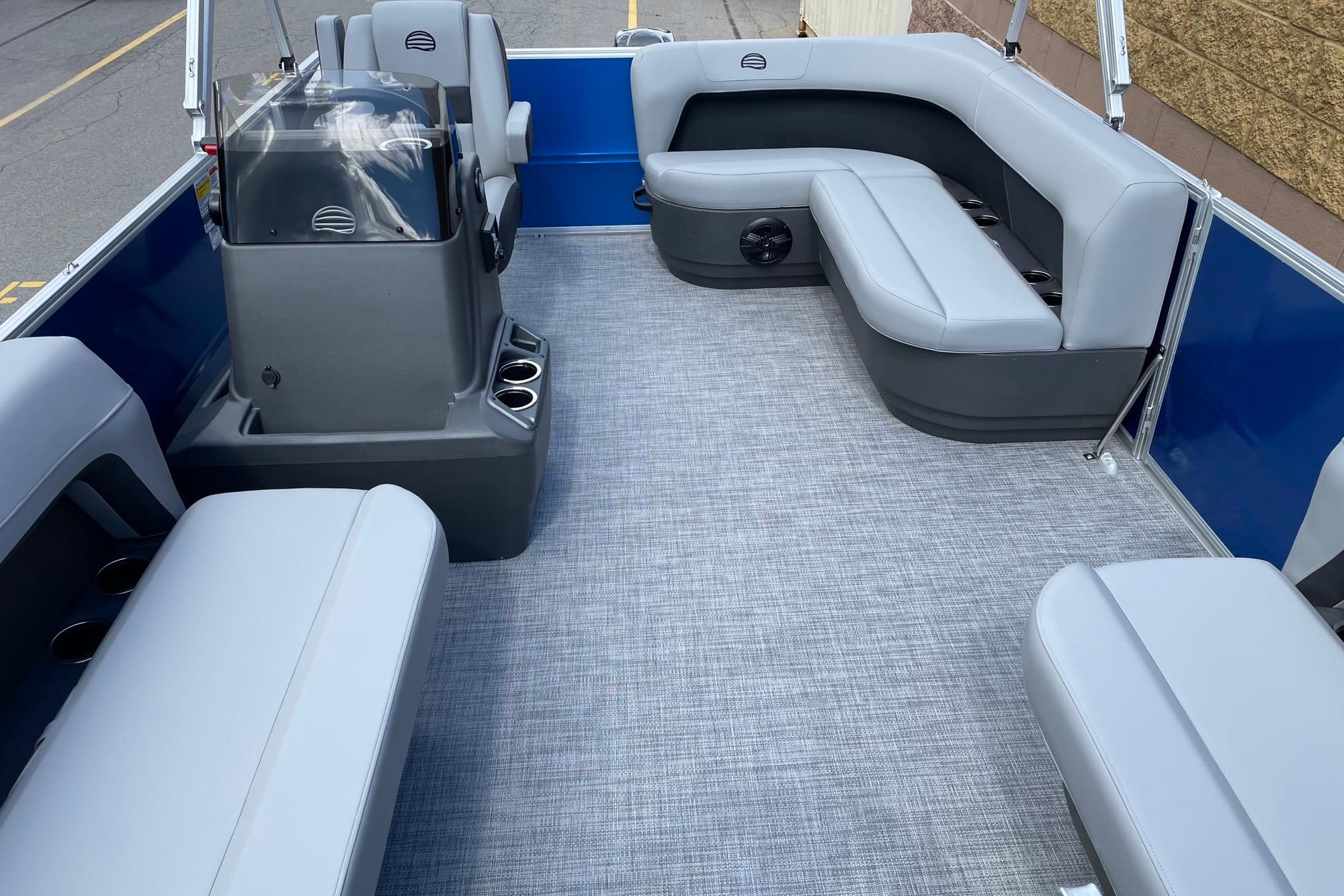 2026 Sun Tracker Party Barge 16 DLX interior with gray seating and modern design.