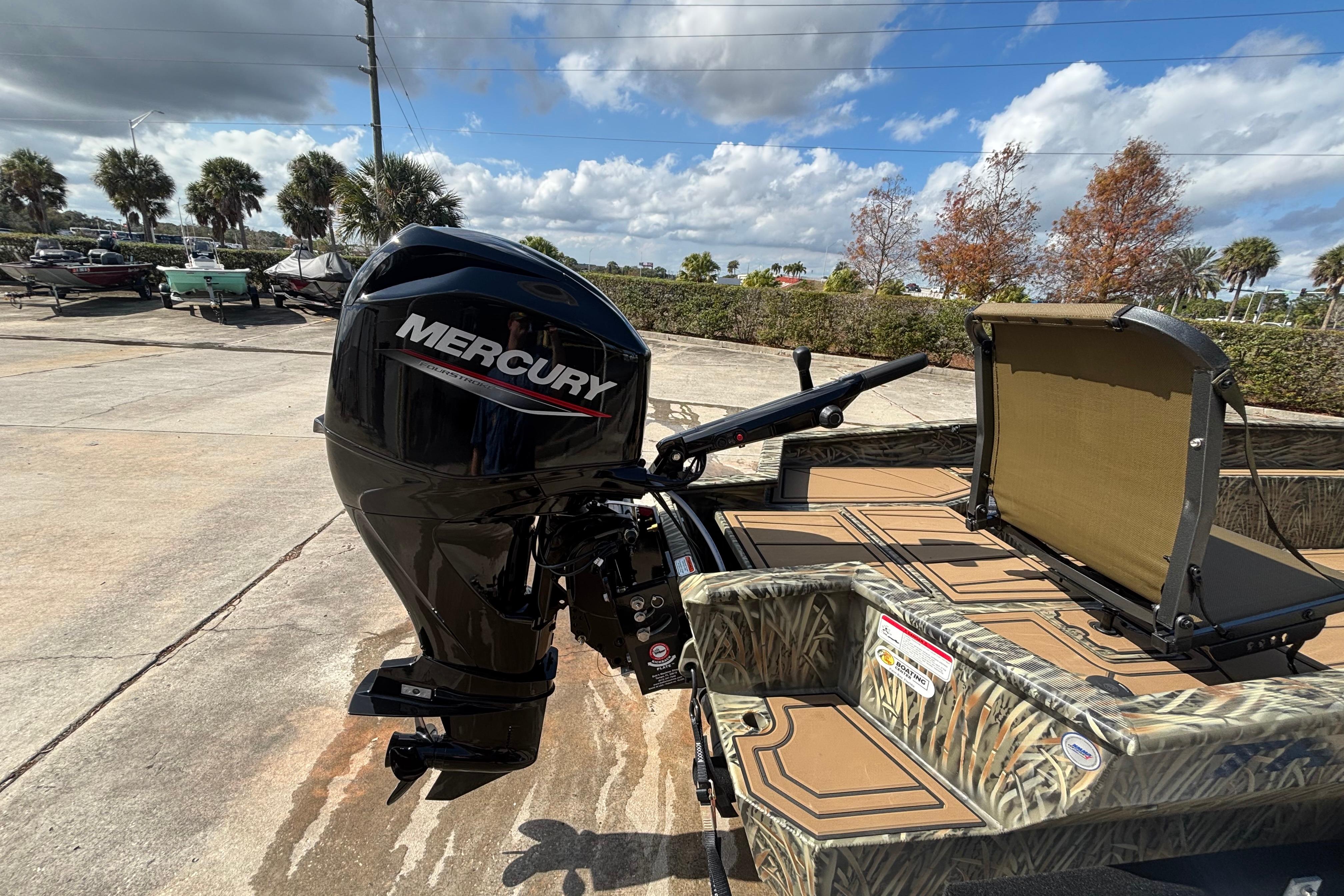 2026 Tracker Grizzly 1650 T Prairie Wings Edition with Mercury outboard motor in a sunny outdoor setting.