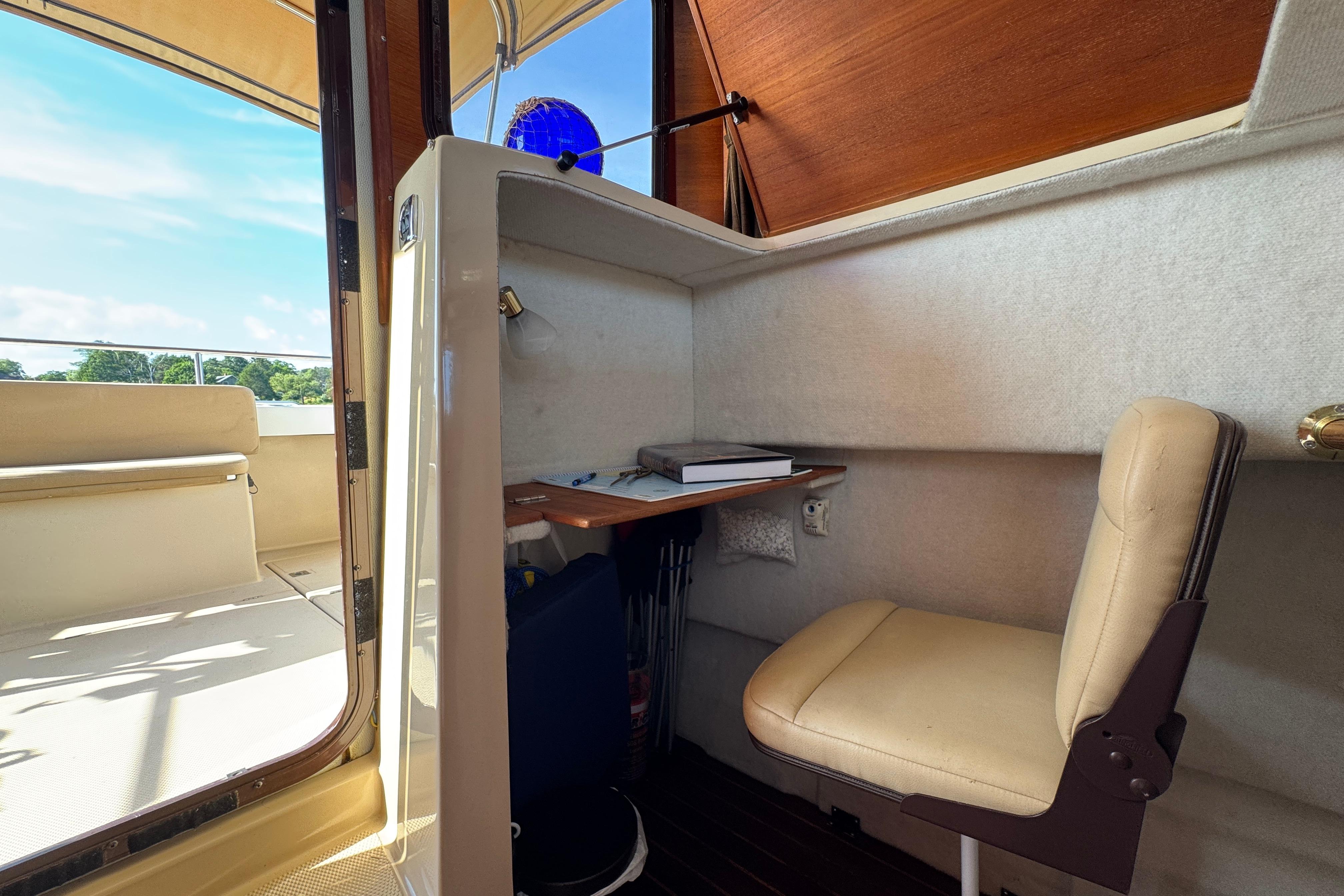 Interior of 2012 Ranger 27 boat with desk and chair setup.