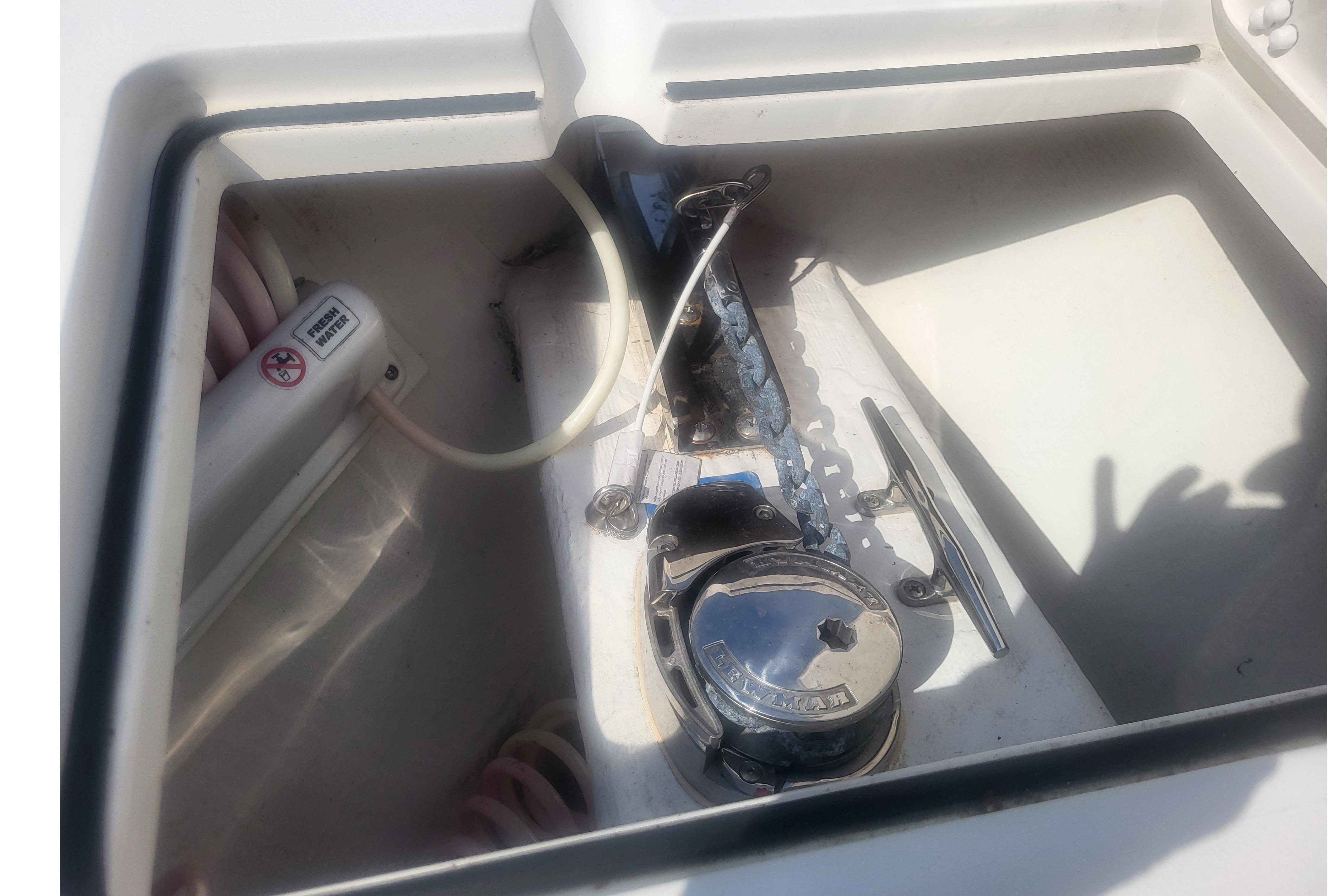 2022 Cobia 262 Center Console anchor locker with windlass and freshwater washdown.