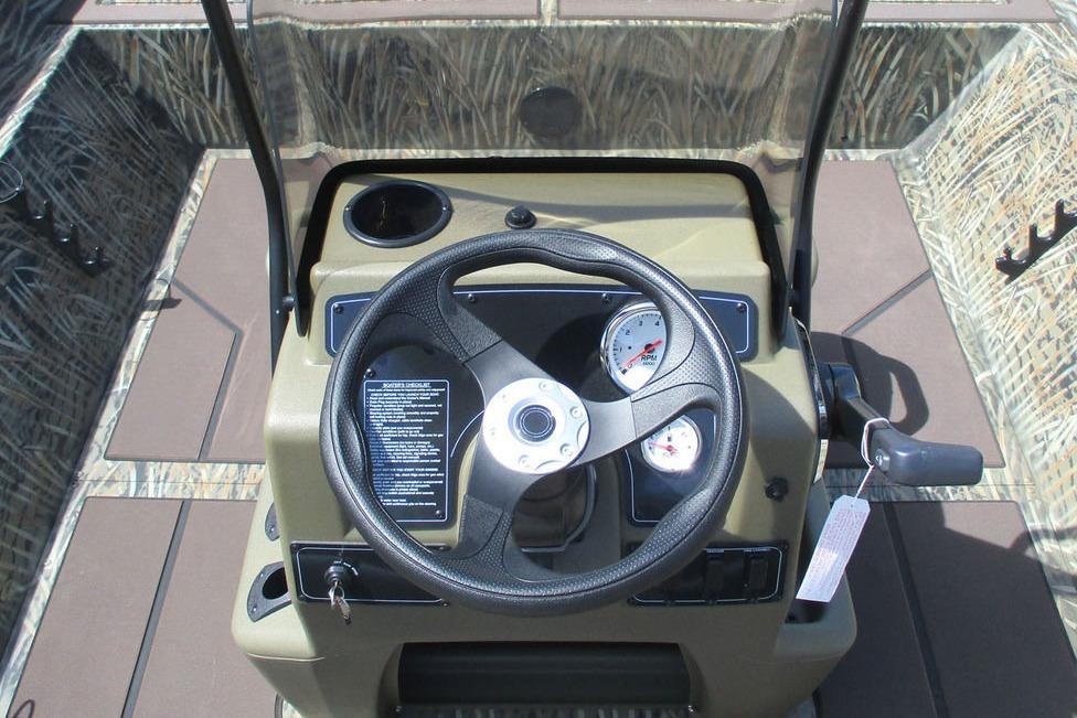 2026 Tracker Grizzly 2072 CC boat console with steering wheel and gauges.