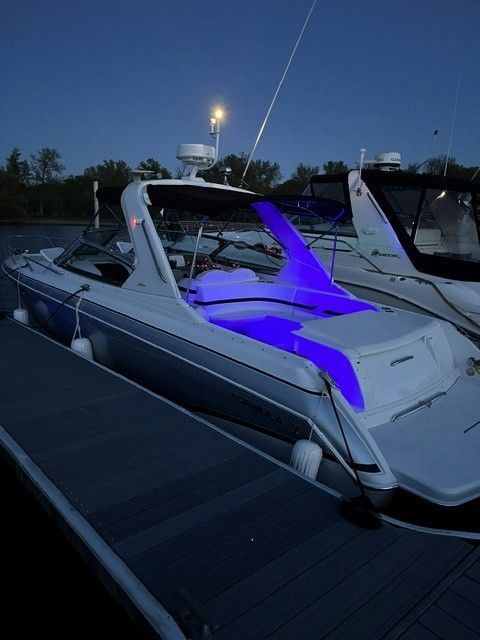 2006 Formula 330 Sun Sport boat with blue lighting at dock.
