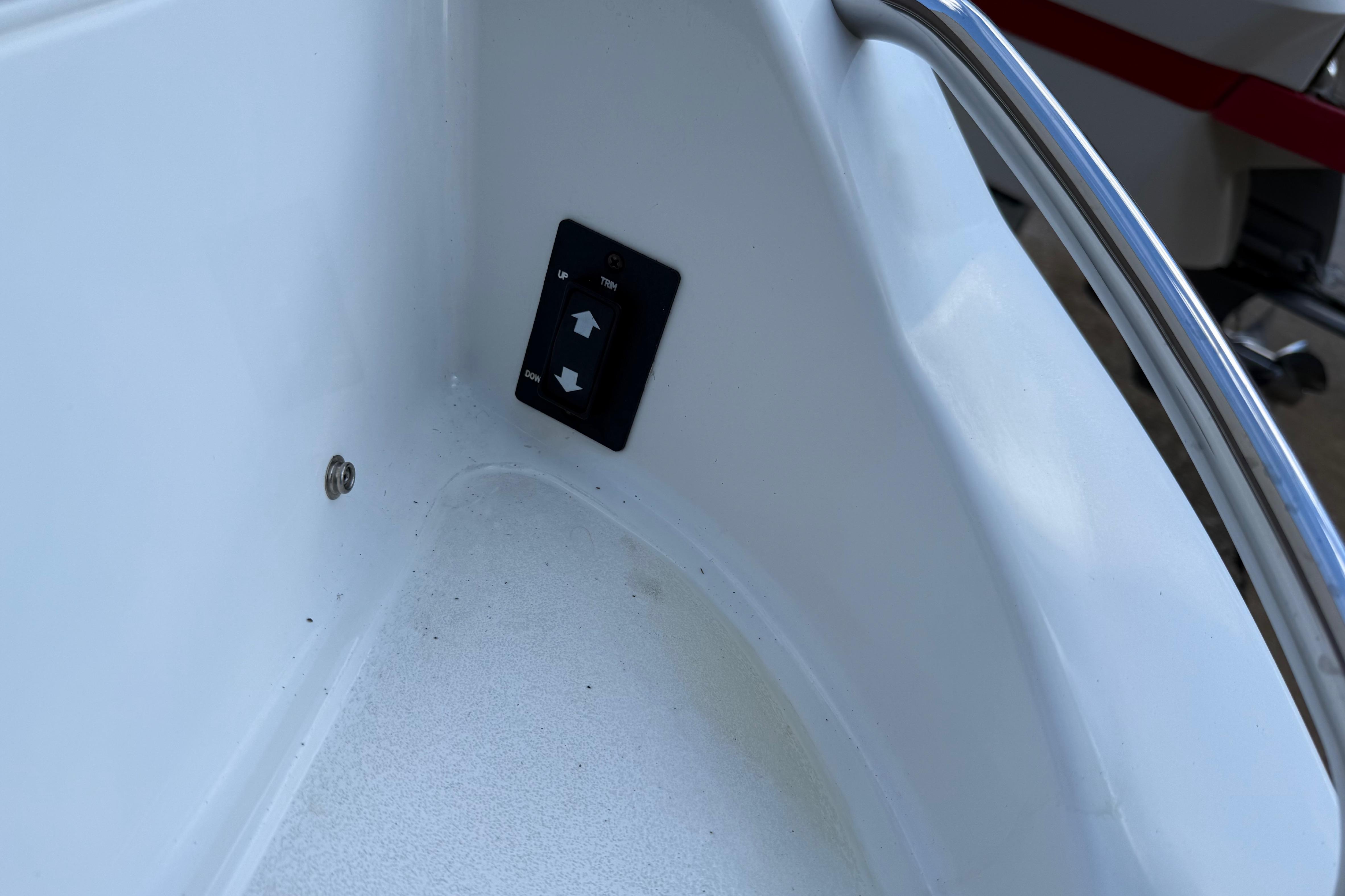 Trim control panel on a 2015 Cobalt 200 boat, featuring up and down arrows.