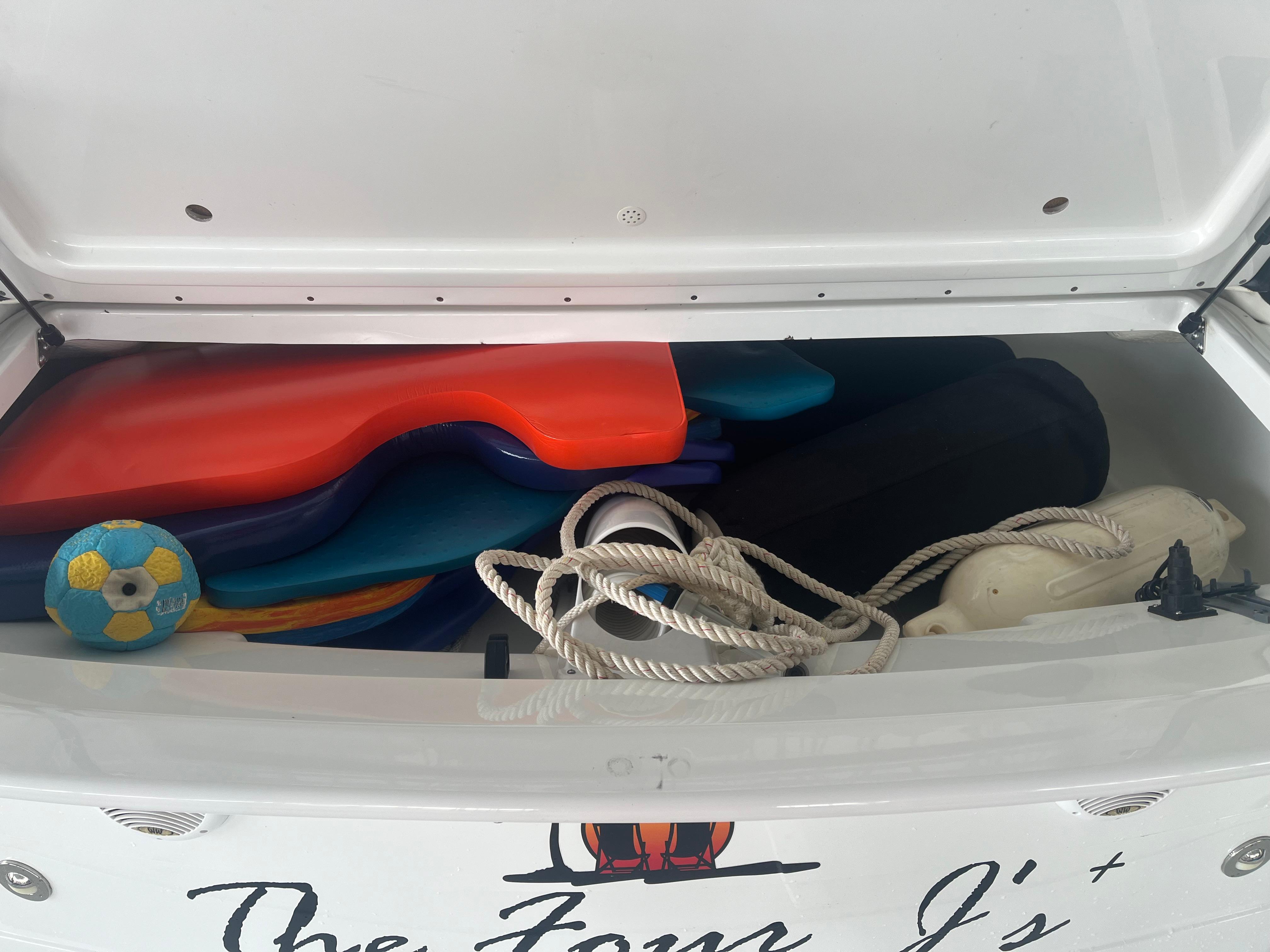 Storage compartment of 2014 Formula 45 Yacht with ropes, floats, and a ball.
