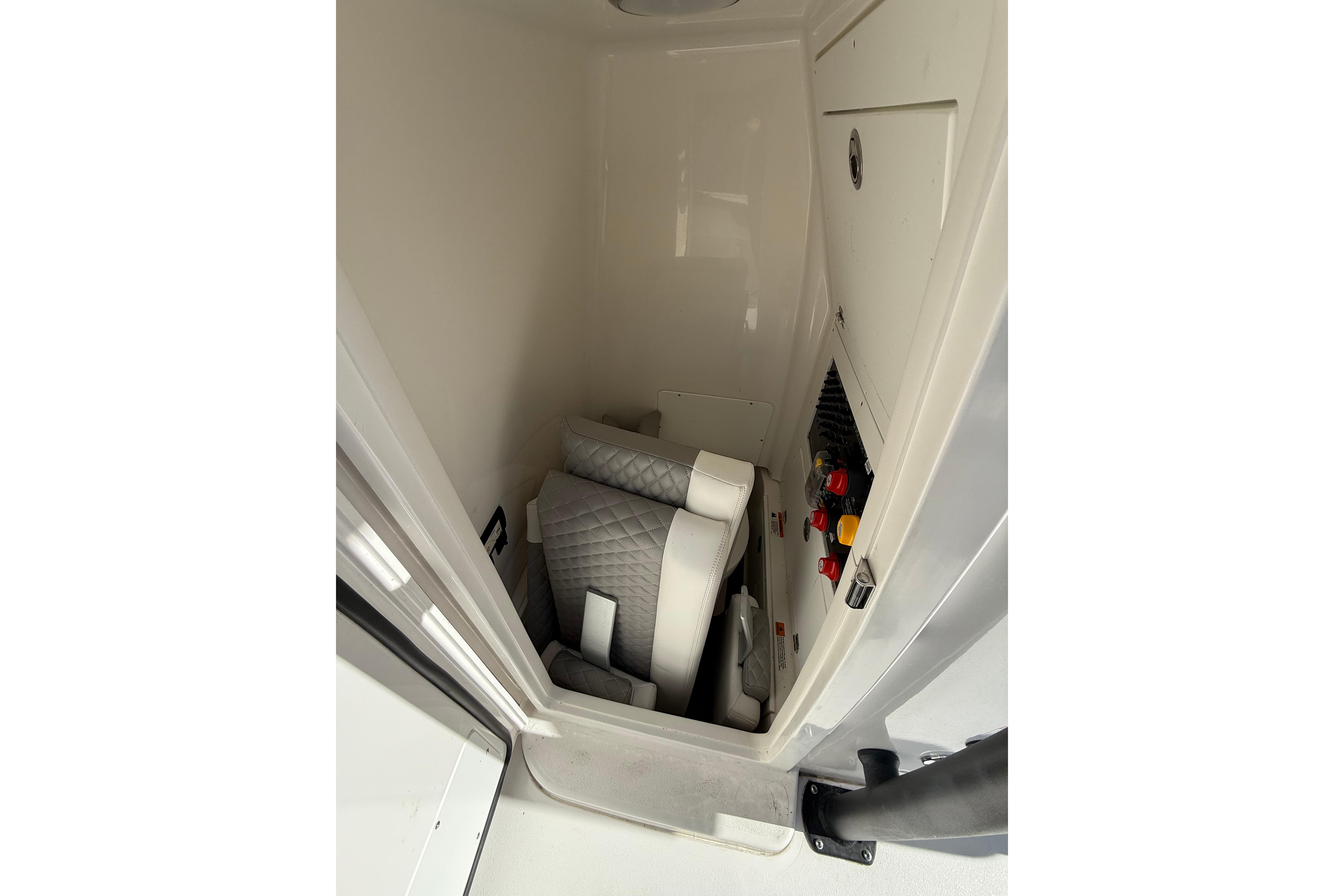 2023 Caymas 281 HB interior storage with cushioned seating and control panel.