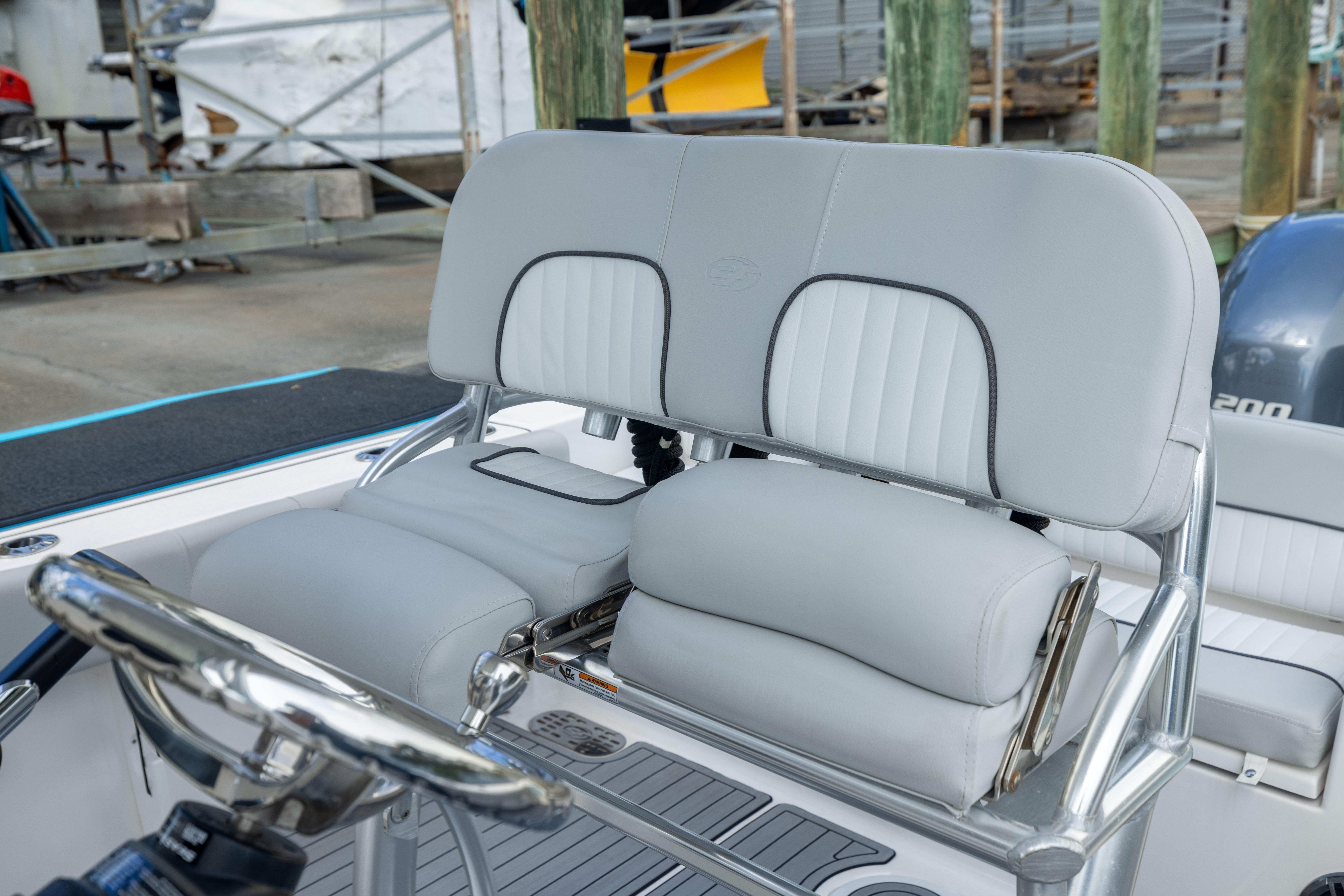 2023 Sea Fox 228 Commander boat helm with cushioned seating and steering wheel.