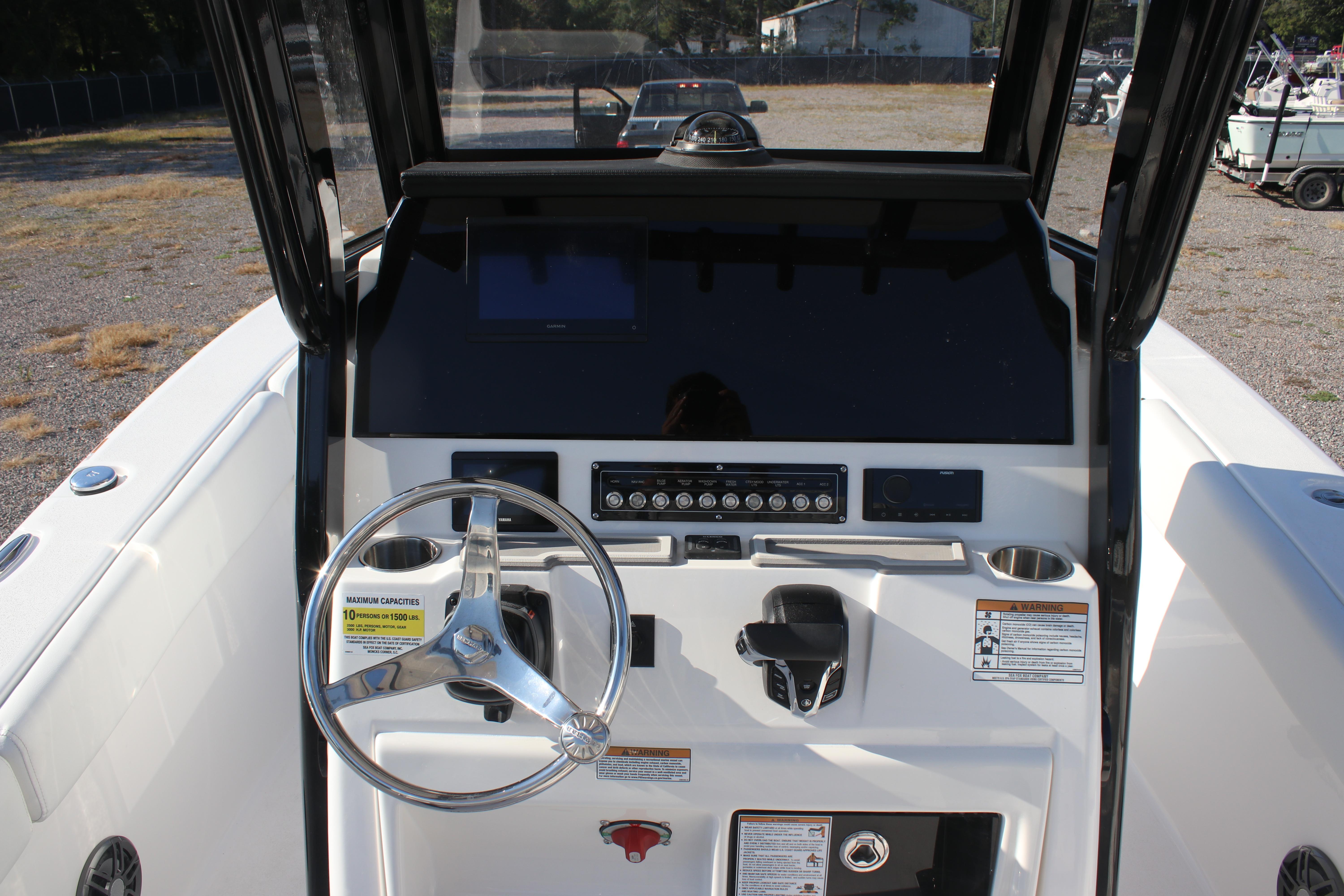 2026 Sea Fox 248 Commander boat dashboard with steering wheel and control panel.