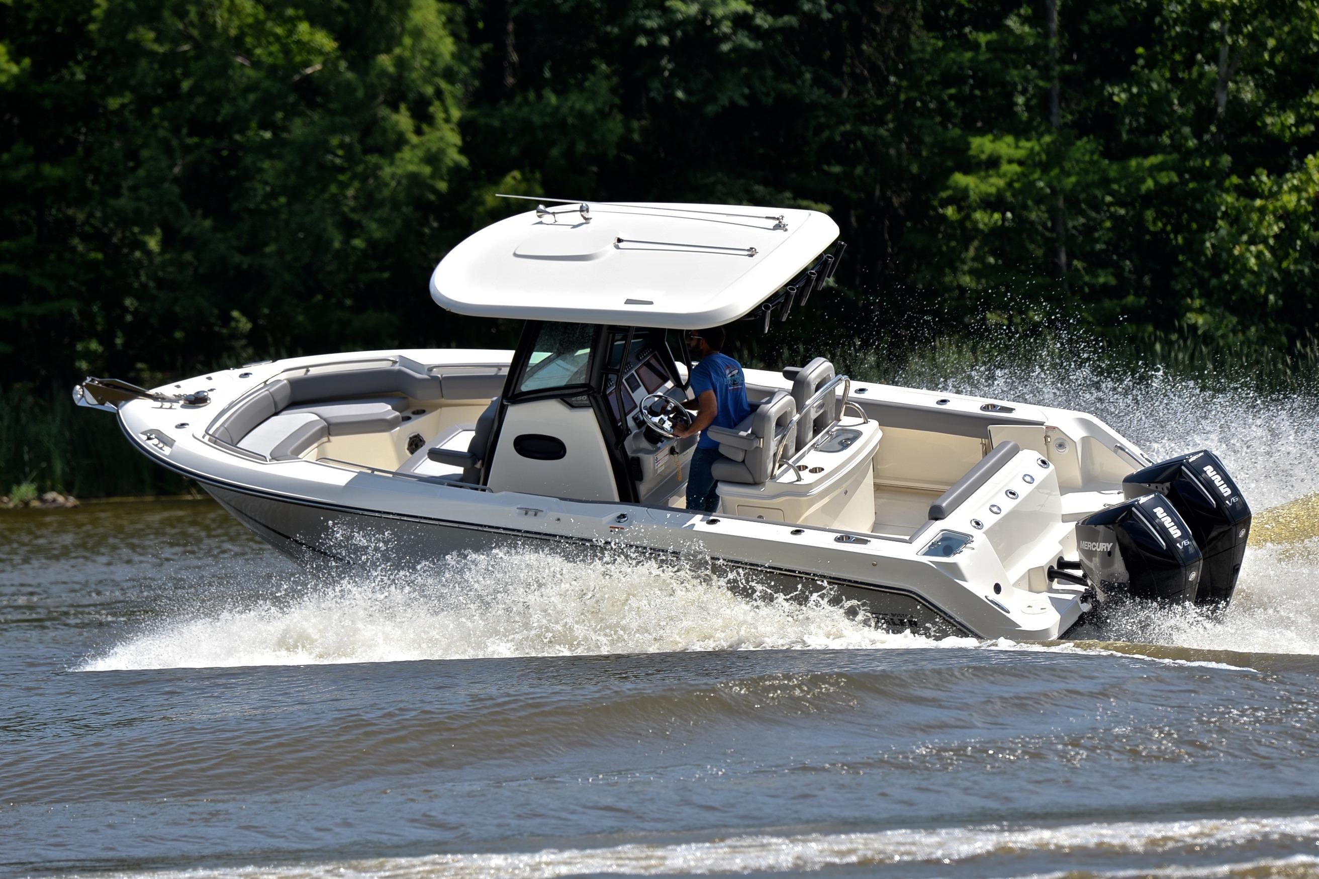 2024 Boston Whaler 250 Outrage cruising on water with dual engines.
