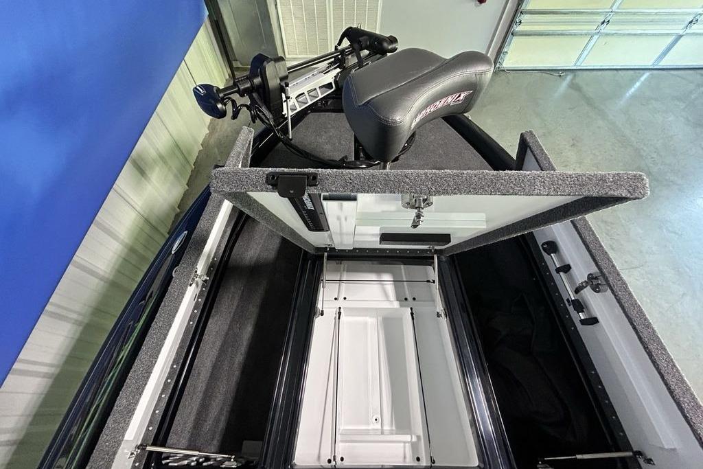 2026 Phoenix 819 ZXL boat interior with open storage compartment and seat.