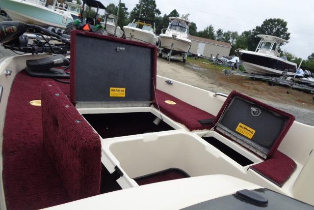 1996 Quantum 180 XD boat with open storage compartments, red interior, and surrounding boats.