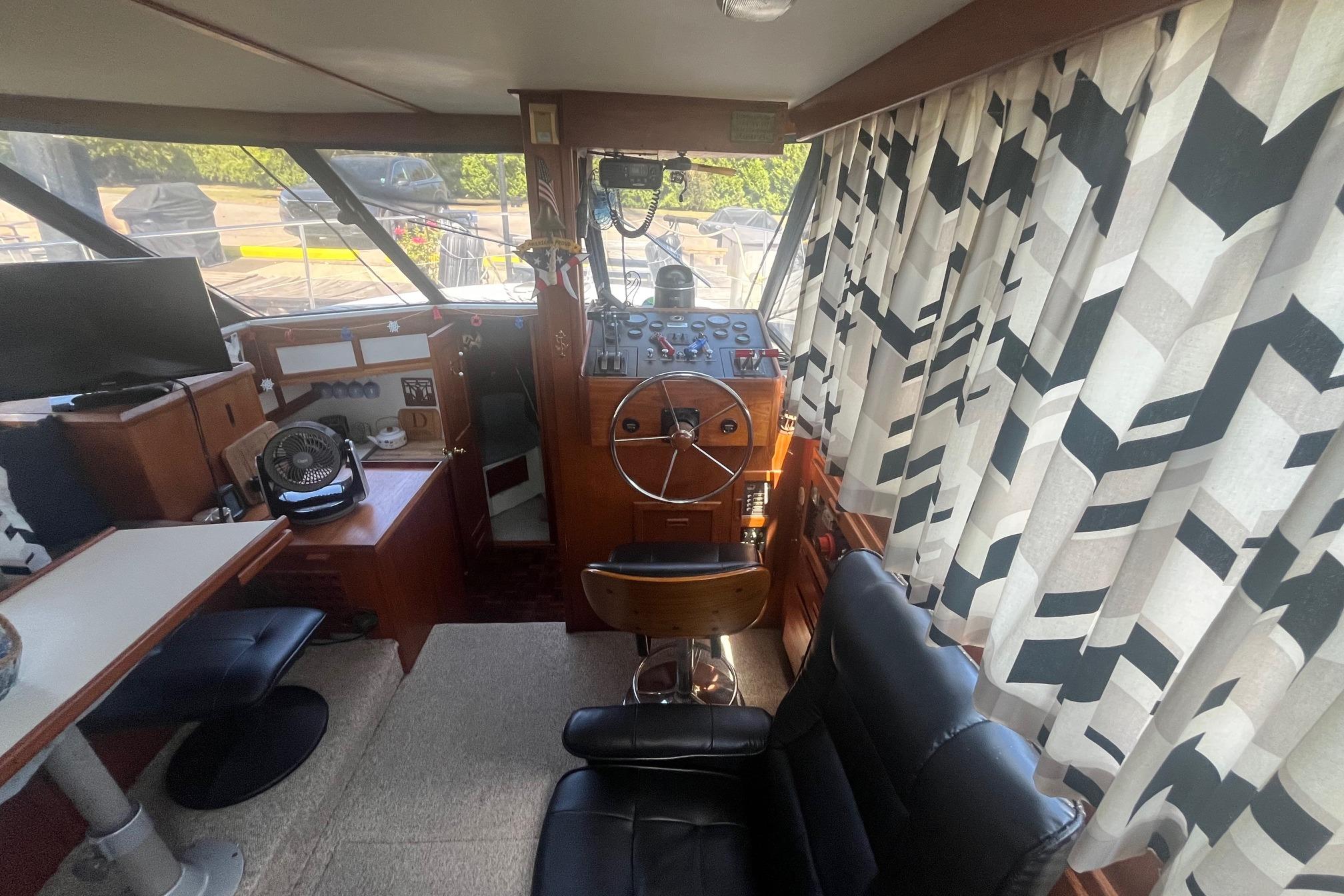 Interior of 1990 Cooper Prowler 35 boat with steering wheel and seating area.