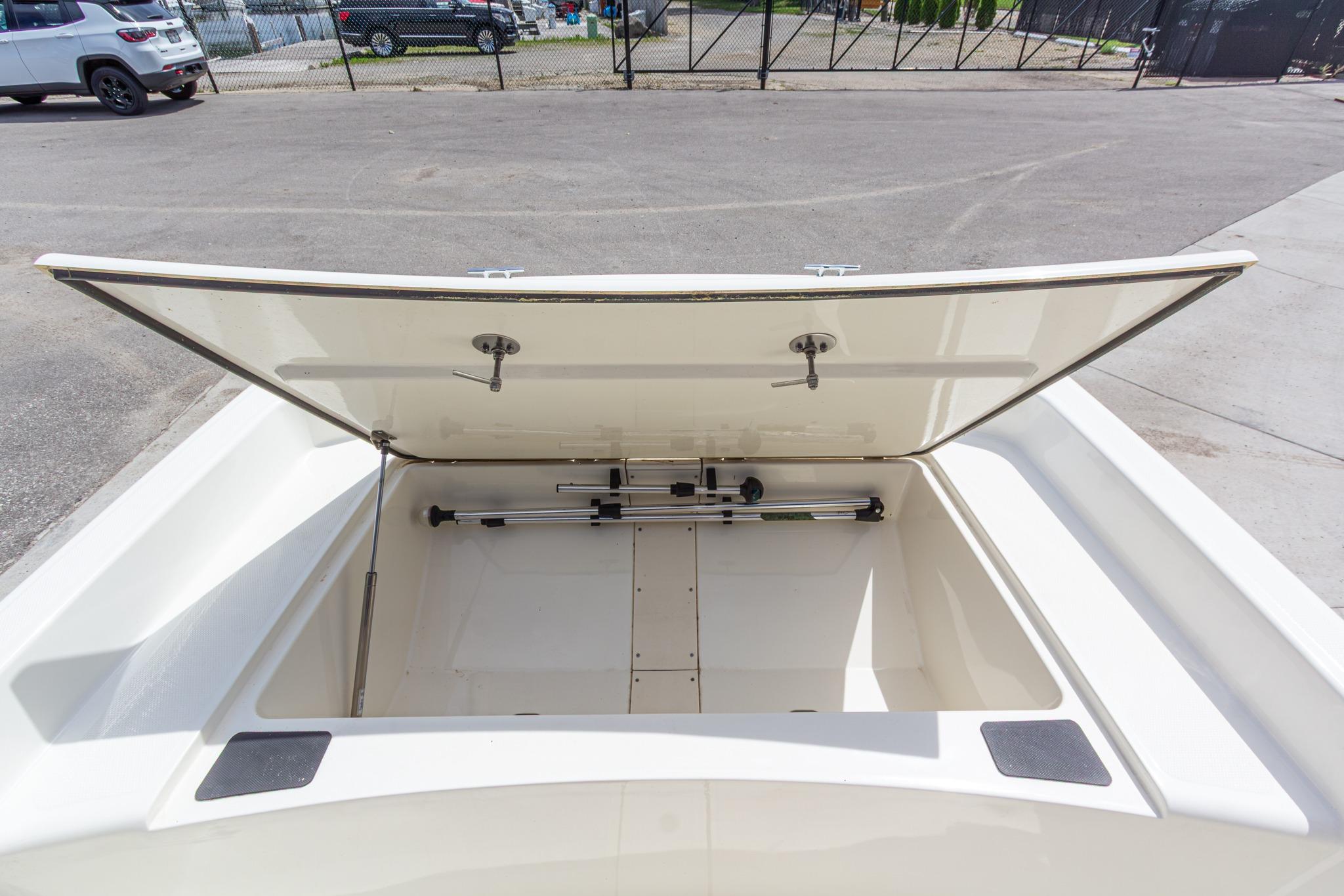 Open storage compartment of a 2020 Mako Pro Skiff 15 CC boat.