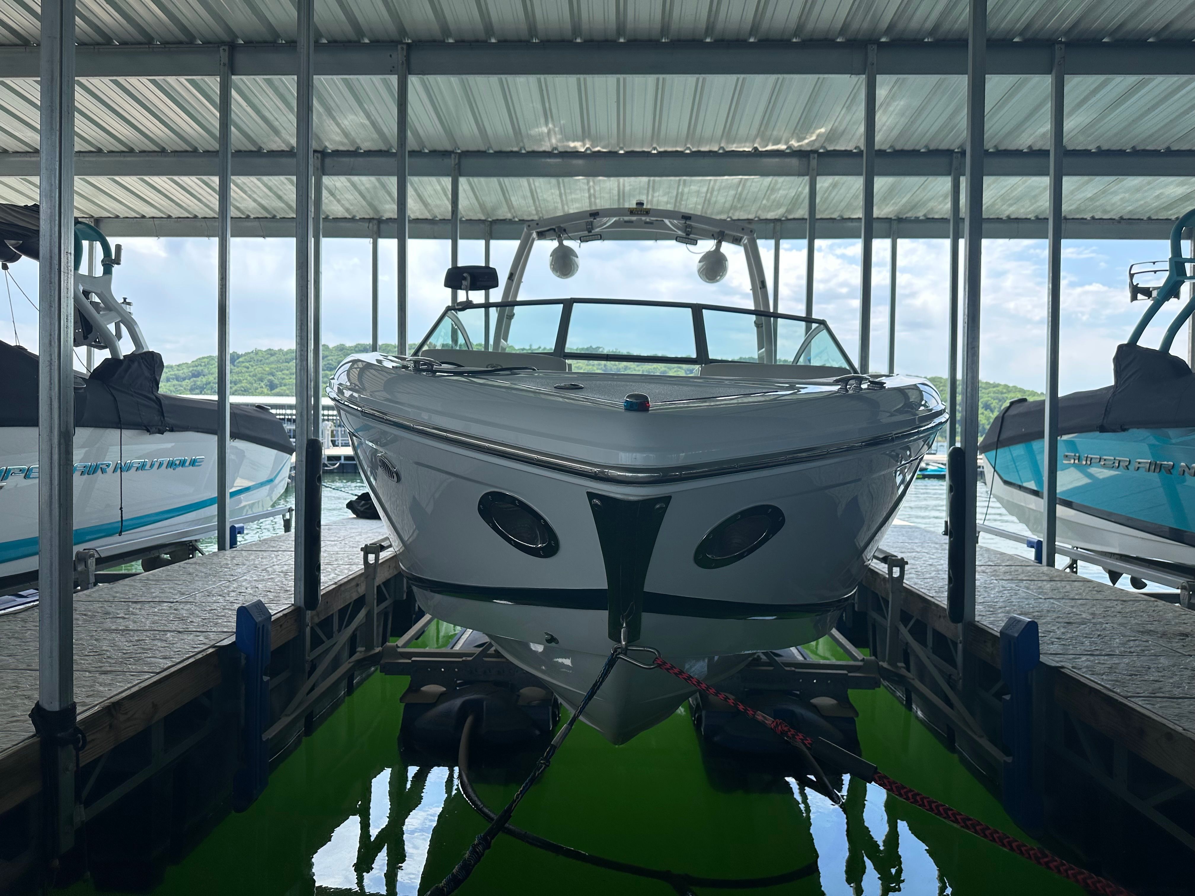 2011 Cobalt A25 docked in a covered boathouse.