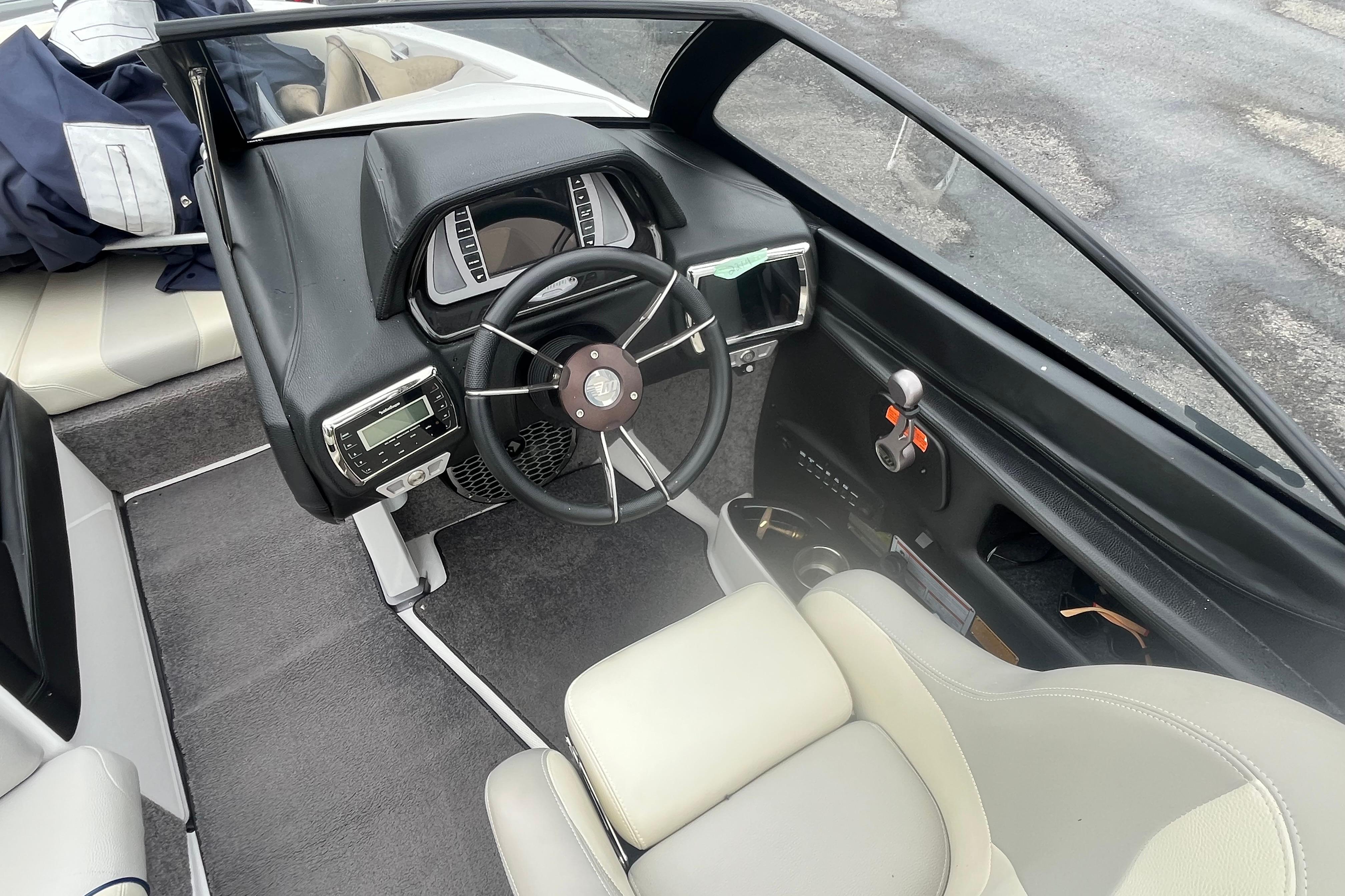 2014 Malibu Wakesetter 23 LSV boat interior with steering wheel and dashboard controls.