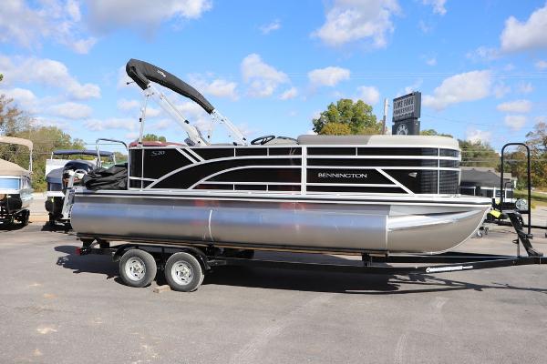 2024 Bennington 20 SL pontoon boat on trailer under blue sky.