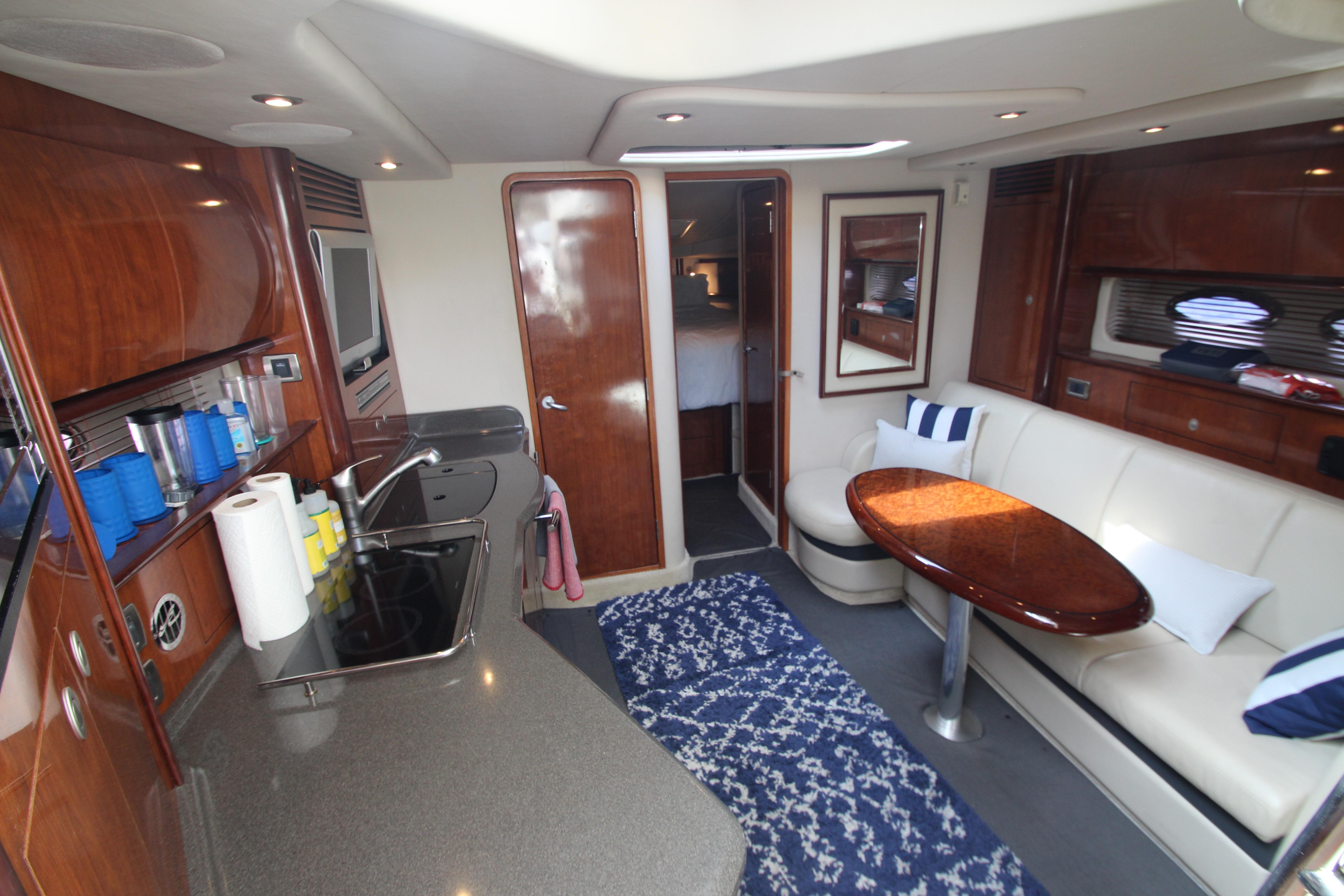 Luxurious interior of 2004 Sea Ray 40 Sundancer yacht with modern kitchen and seating area.