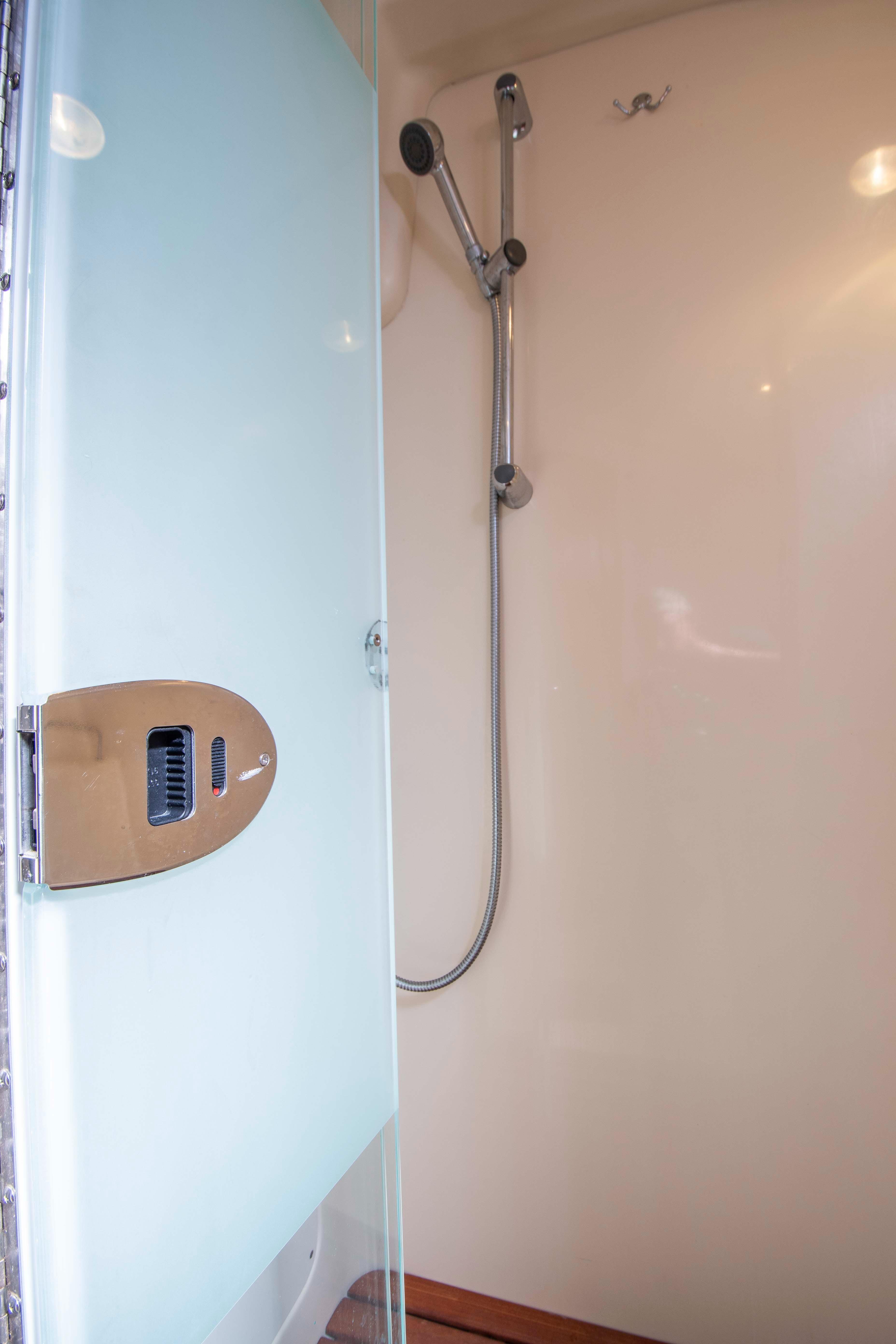 Shower area in 2005 Hunter 45 CC yacht with glass door and modern fixtures.
