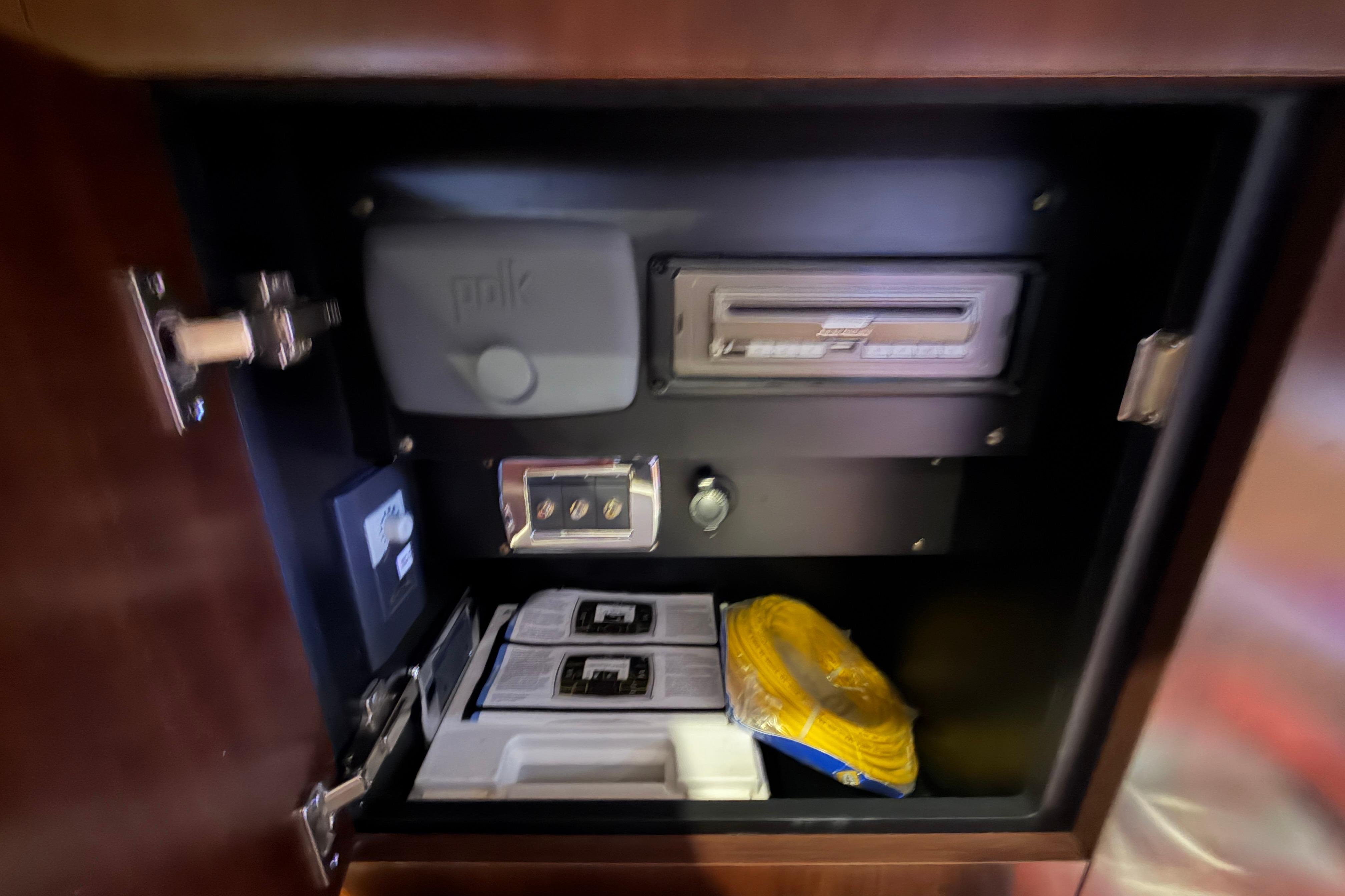 Interior storage compartment of 2018 Chaparral 347 SSX boat with audio equipment.
