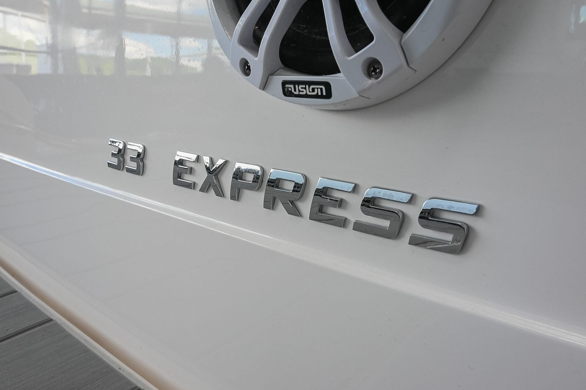 2021 Regal 33 Express boat nameplate with Fusion speaker detail.