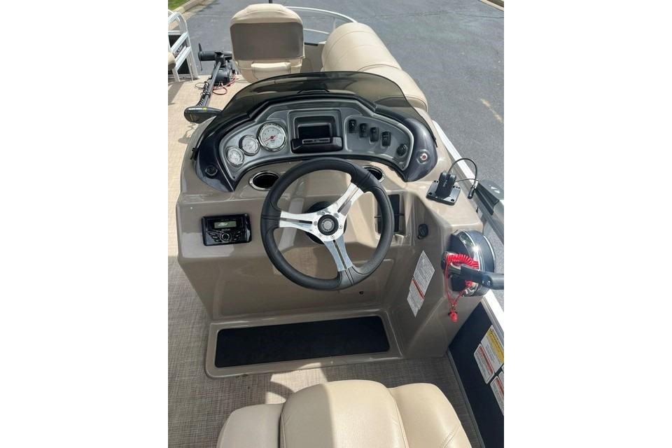 2023 SUNTRACKER Fishing Barge 20 dashboard with steering wheel and controls.