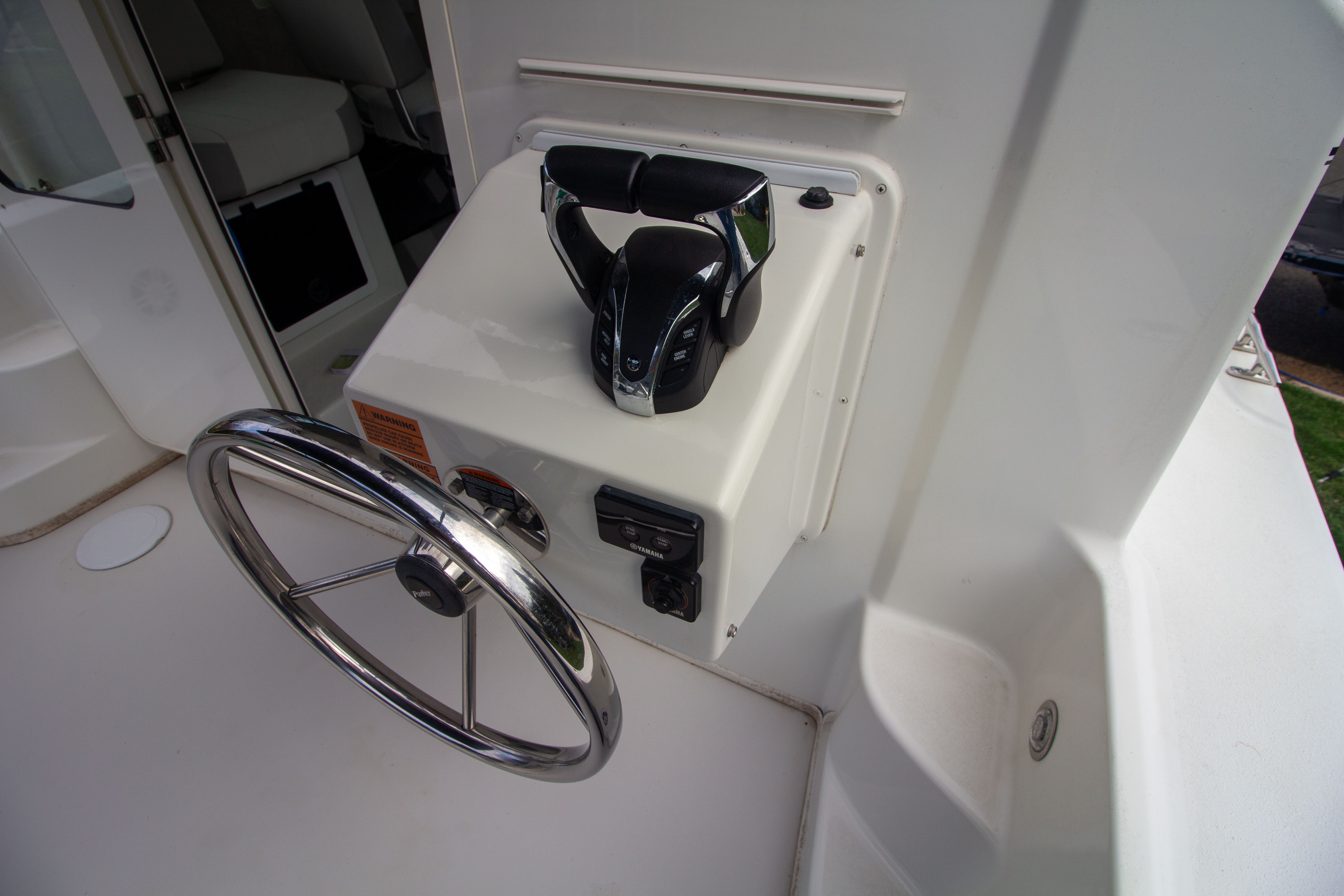 2022 Parker 2520 XLD Sport Cabin helm with steering wheel and throttle control.