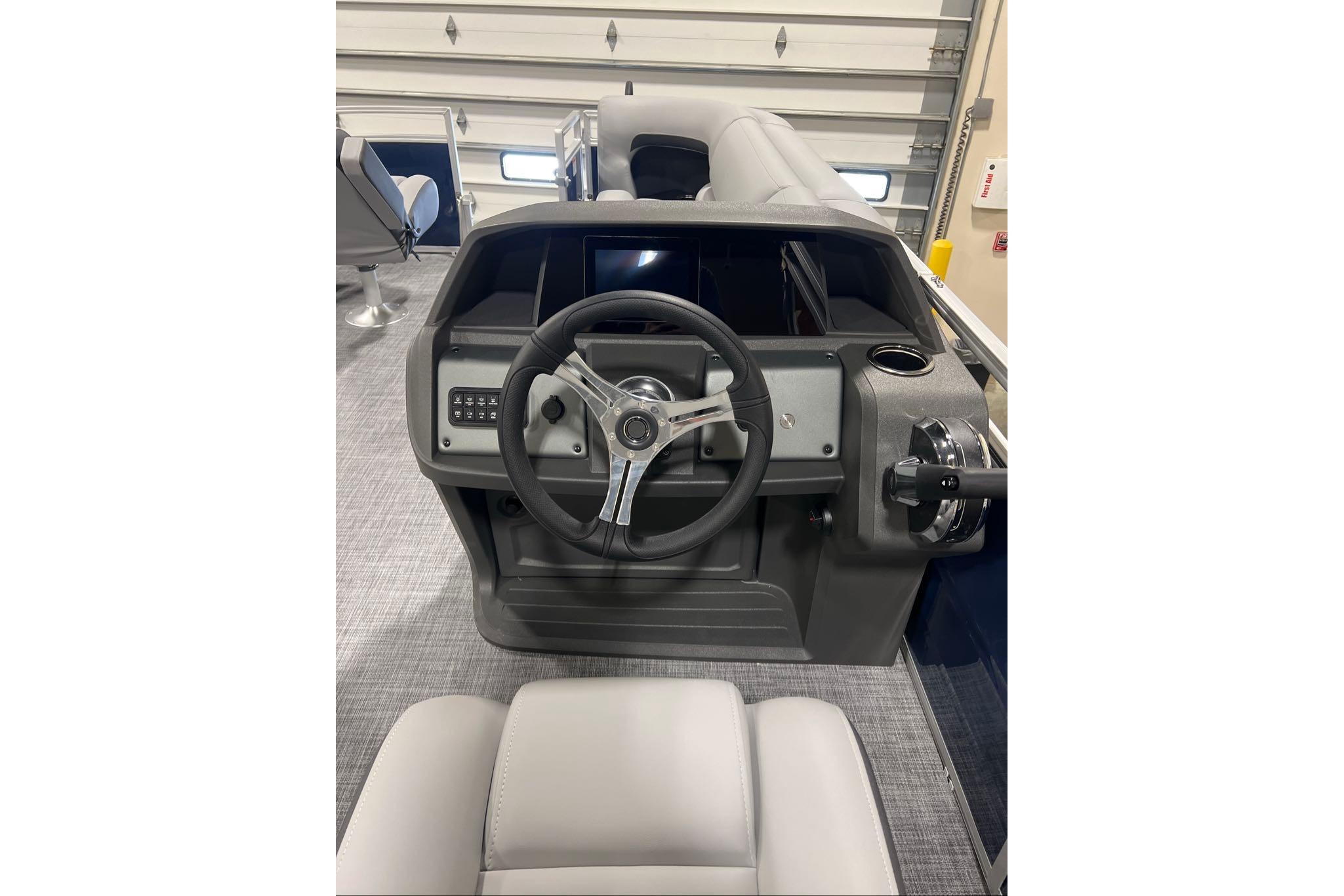2026 Sun Tracker SportFish 20 DLX boat dashboard with steering wheel and controls.