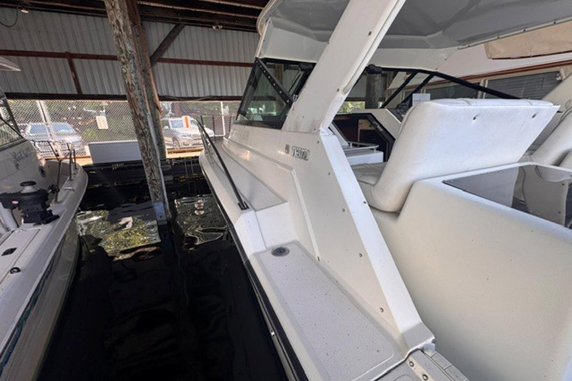 1988 Tiara Yachts 3300 Open docked in a covered marina.