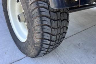 Close-up of a 2012 Avalon Tahoe tire on a concrete surface.