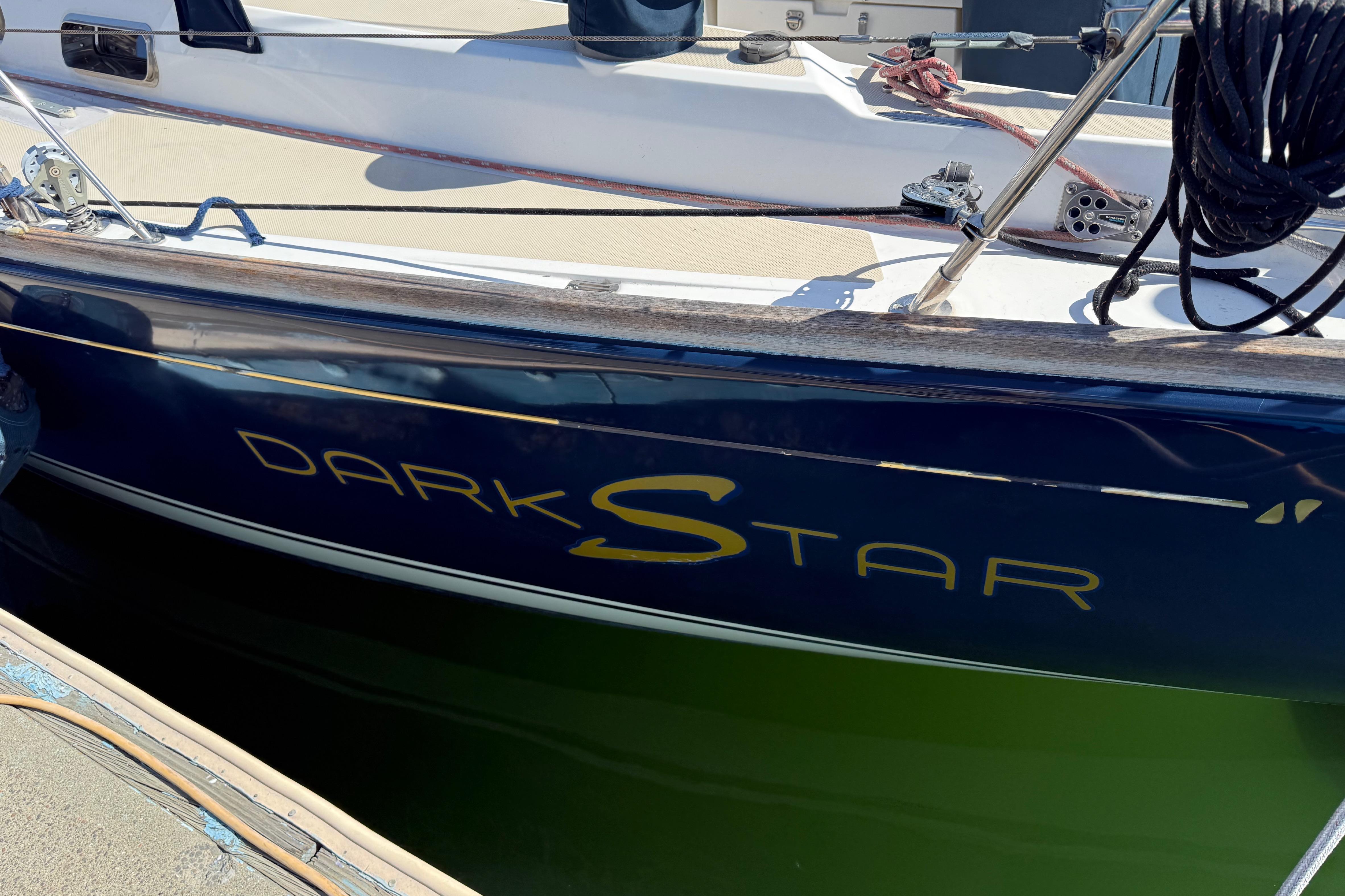 Sailboat "Dark Star" docked, Sabre 386 model, 2004, with navy blue hull.
