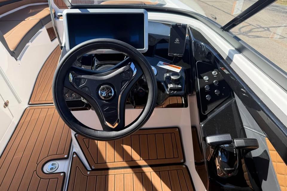 2026 Yamaha Boats 252SD dashboard with steering wheel and modern controls.