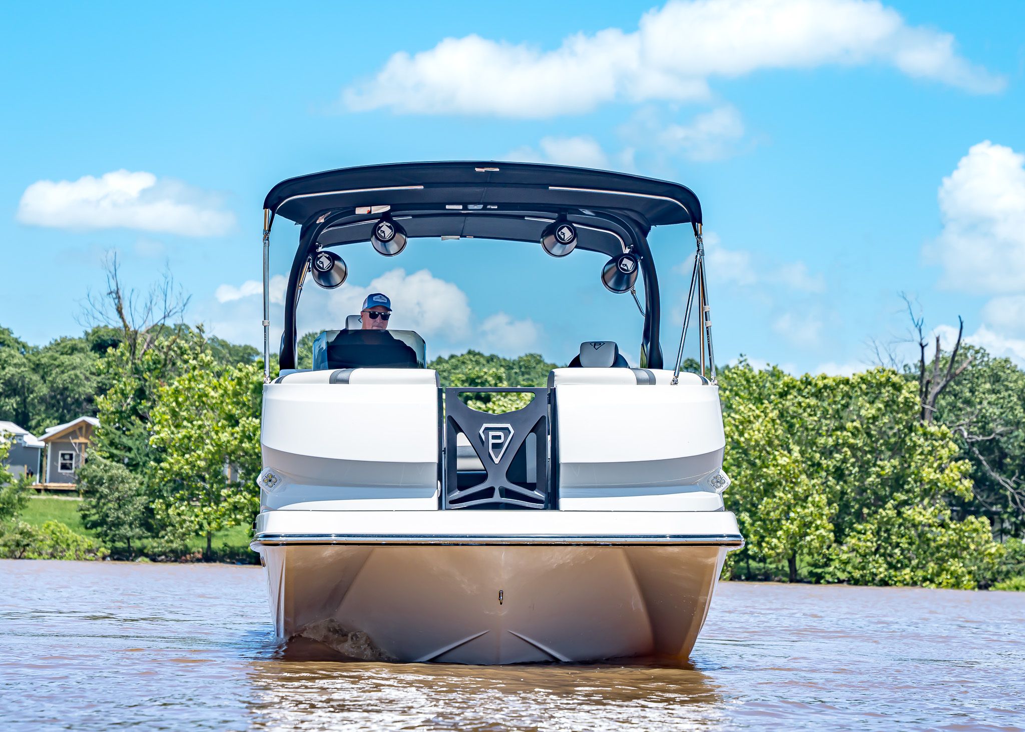 2025 Paradigm 266 SL SURF boat on a serene lake.