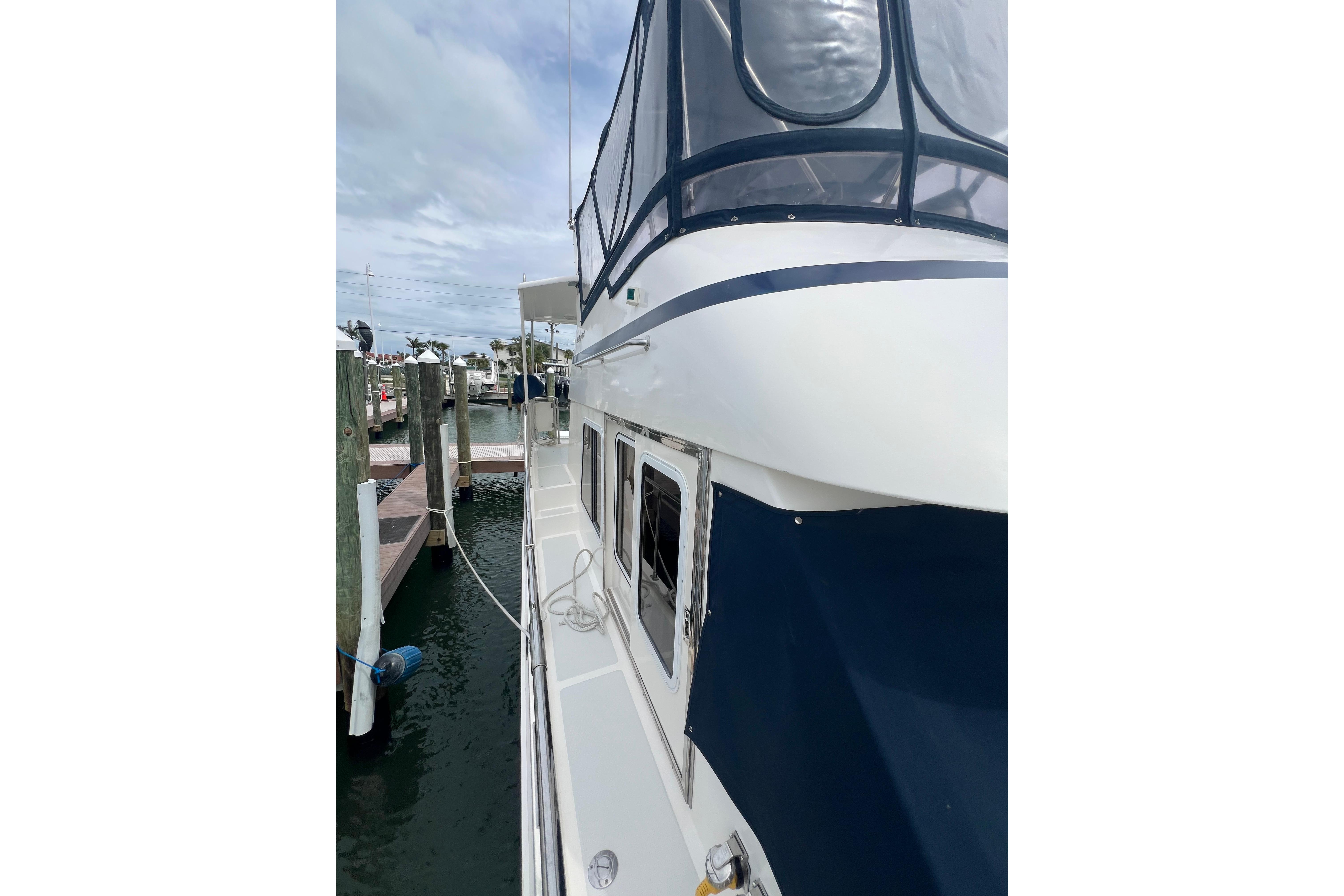 2007 Heritage East 36 Sundeck Trawler docked at marina, side view.