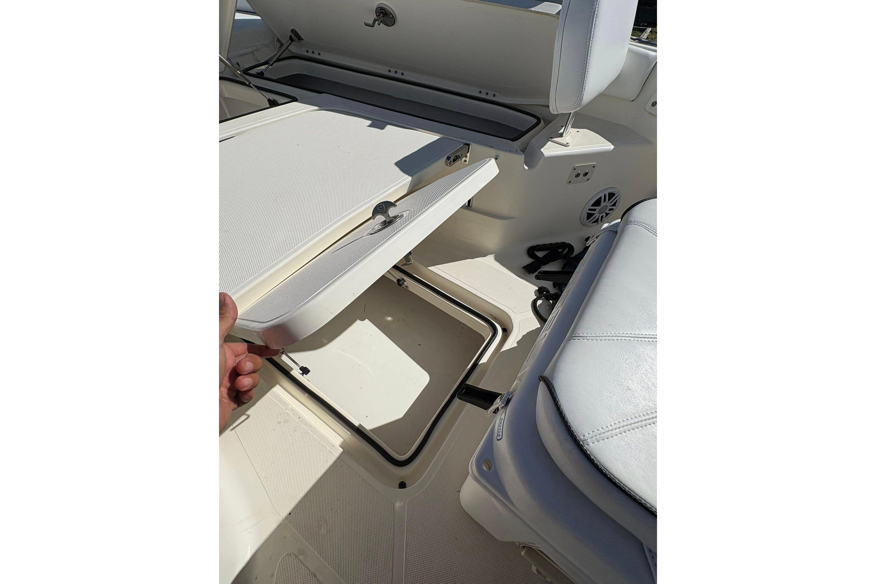 2023 Skeeter SX2550 Family boat interior storage compartment with cushioned seating.