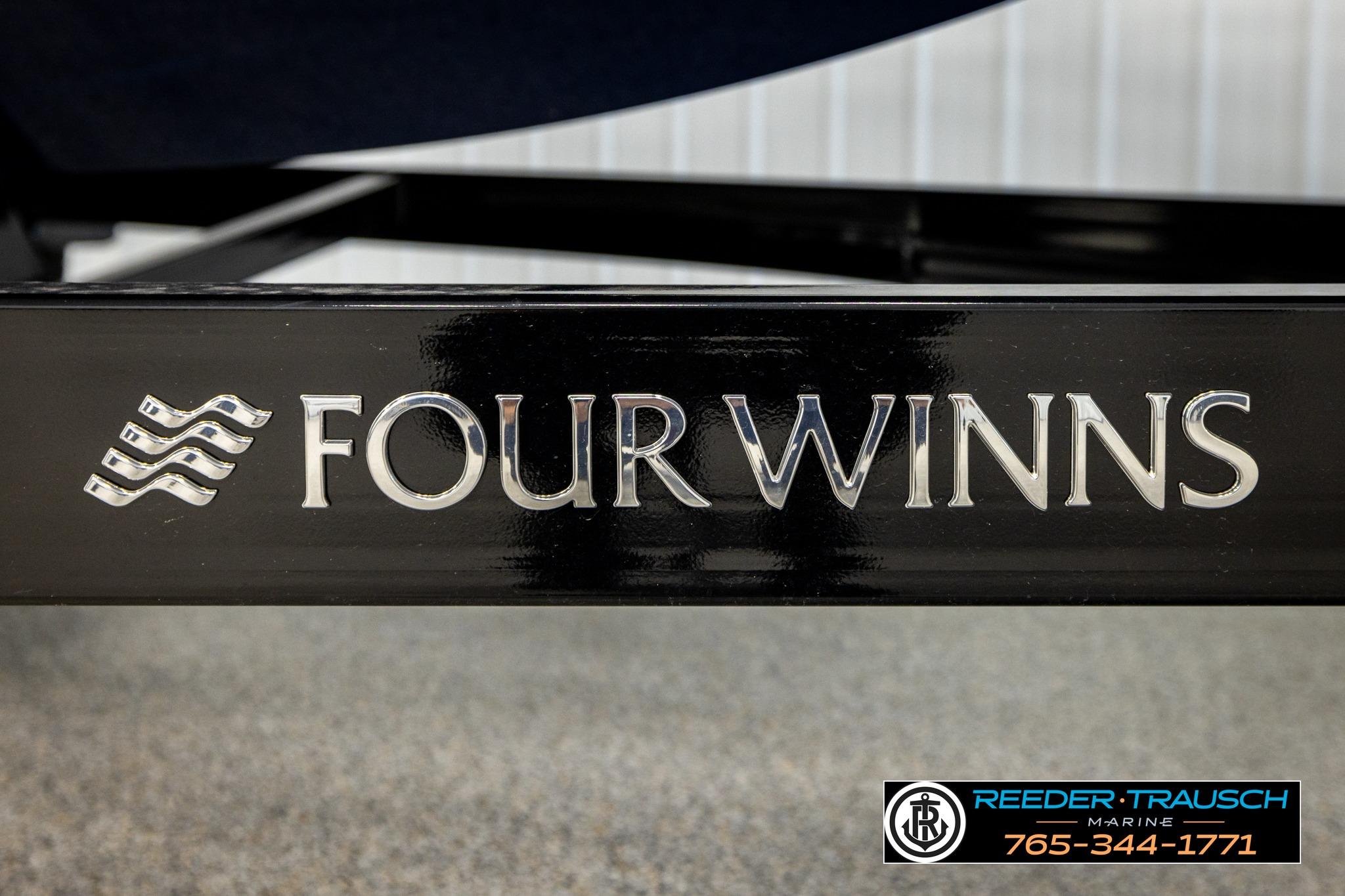 2024 FOURWINNS HD5 Surf boat logo on black surface, Reeder-Trausch Marine contact details visible.