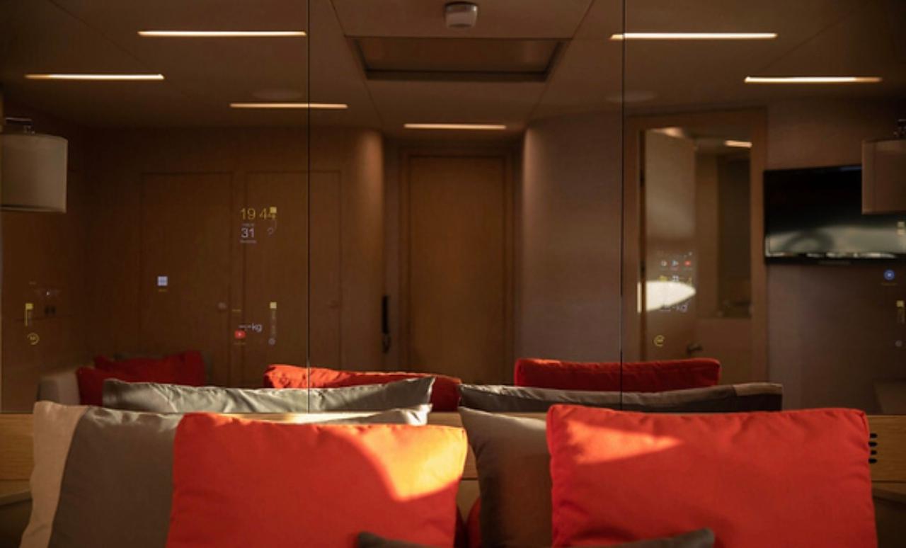 Luxurious interior of 2019 Numarine 78 yacht with modern decor and vibrant cushions.