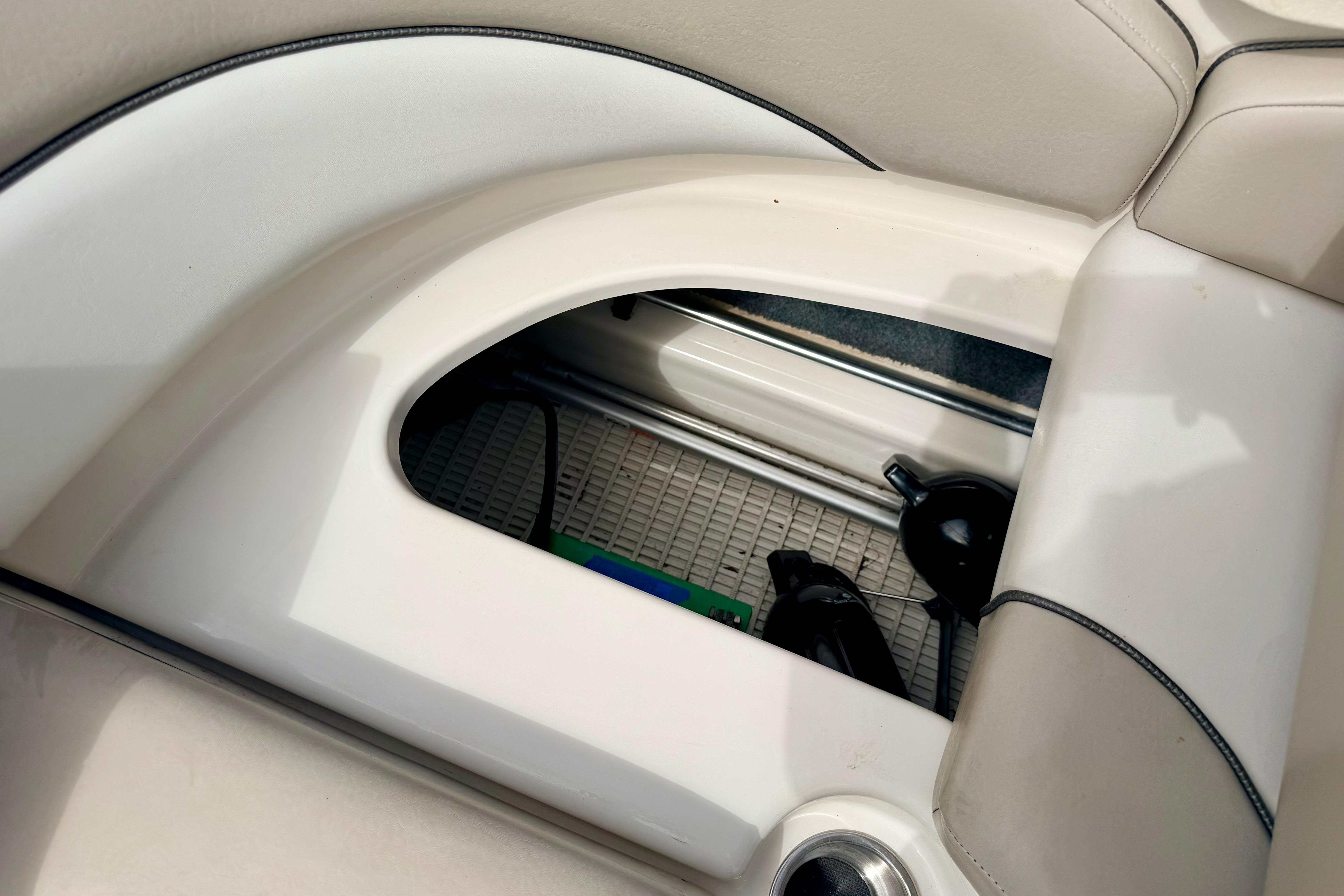 Storage compartment in a 2003 Sea Ray 200 Sundeck boat interior.