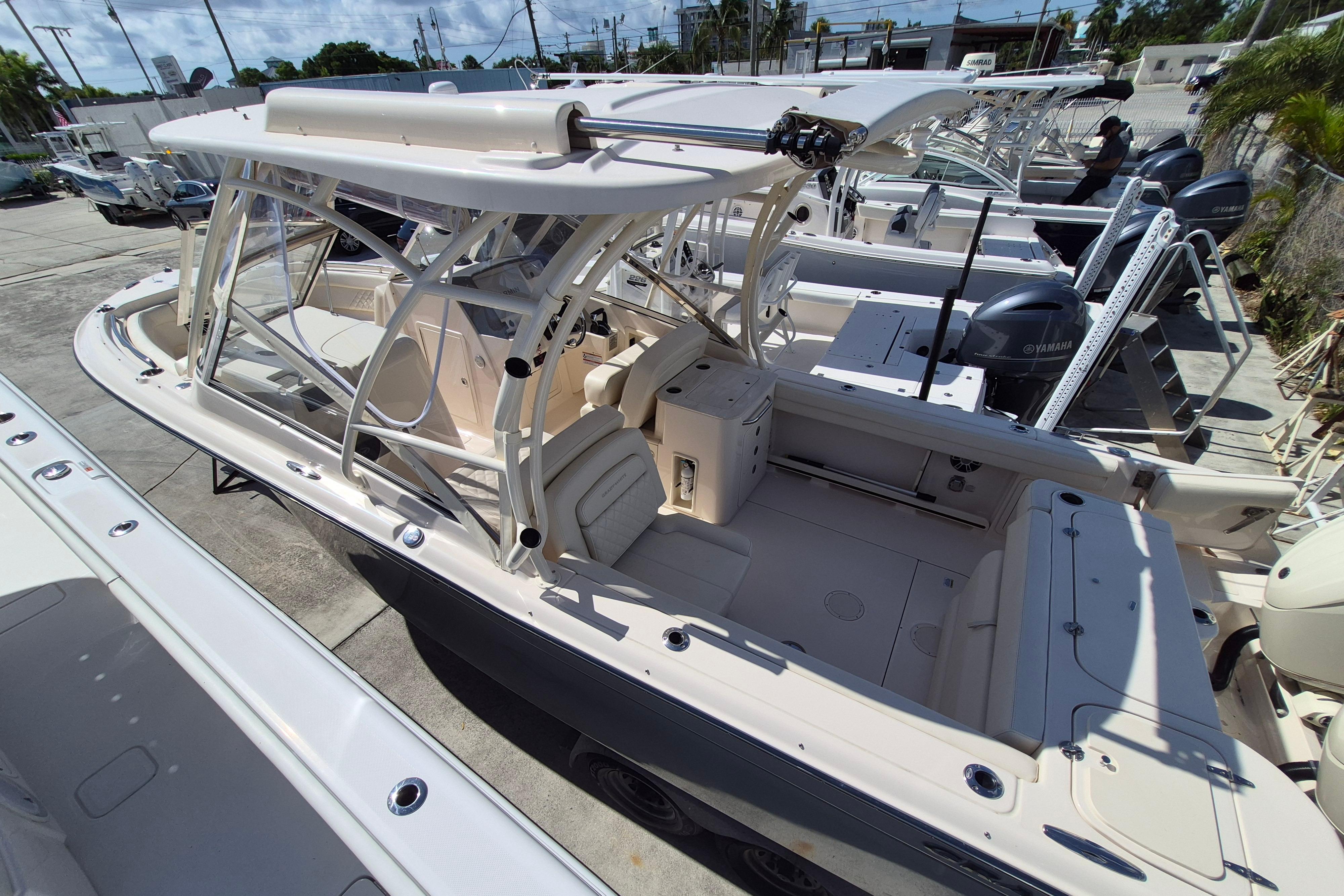 2025 Grady-White Freedom 275 boat with spacious seating and modern design in a marina.