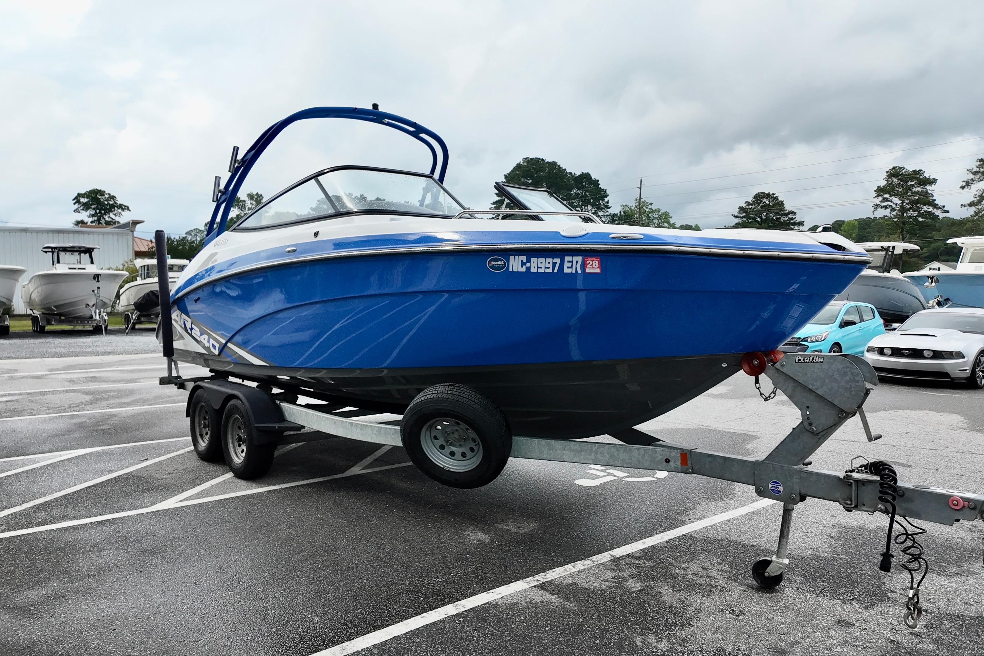 2020 Yamaha Boats AR240 in blue on a trailer, parked in a lot.