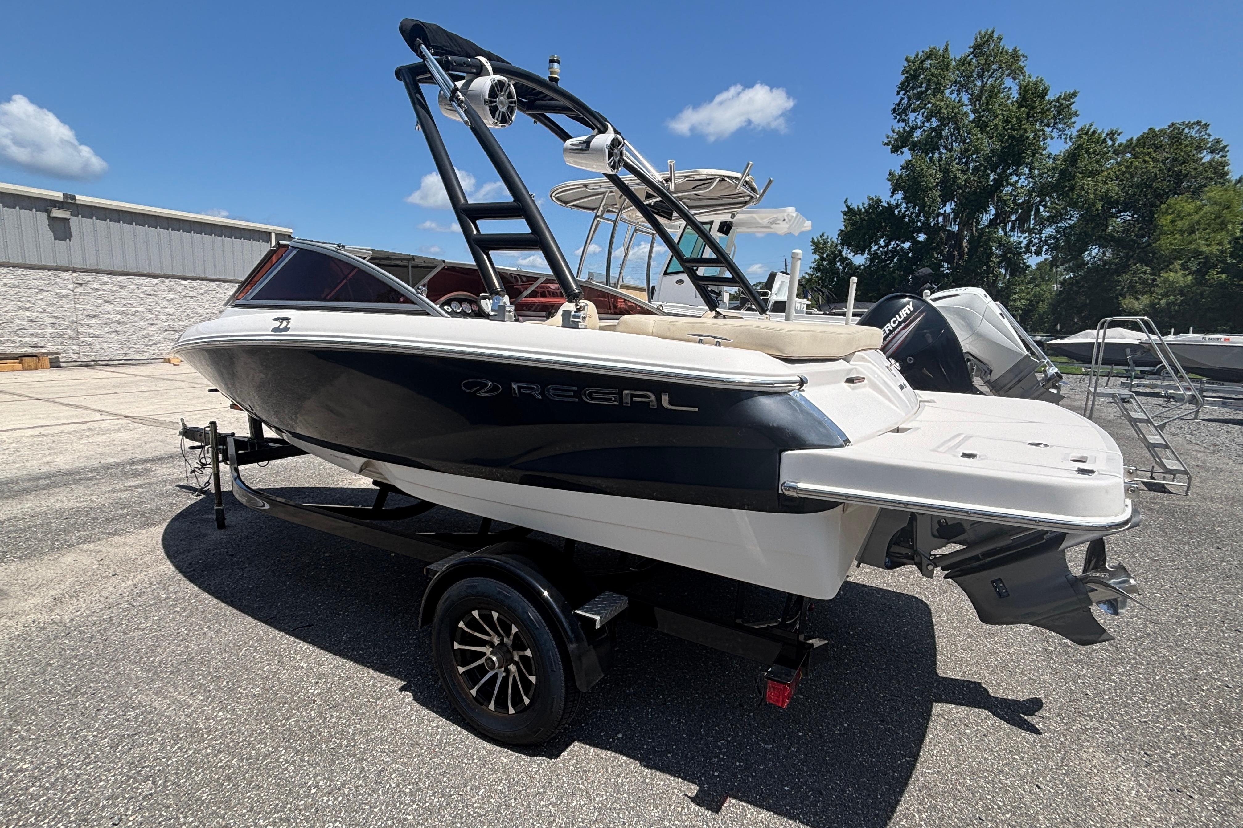 2018 Regal 1900 ES Bowrider boat on trailer, parked outdoors under clear sky.