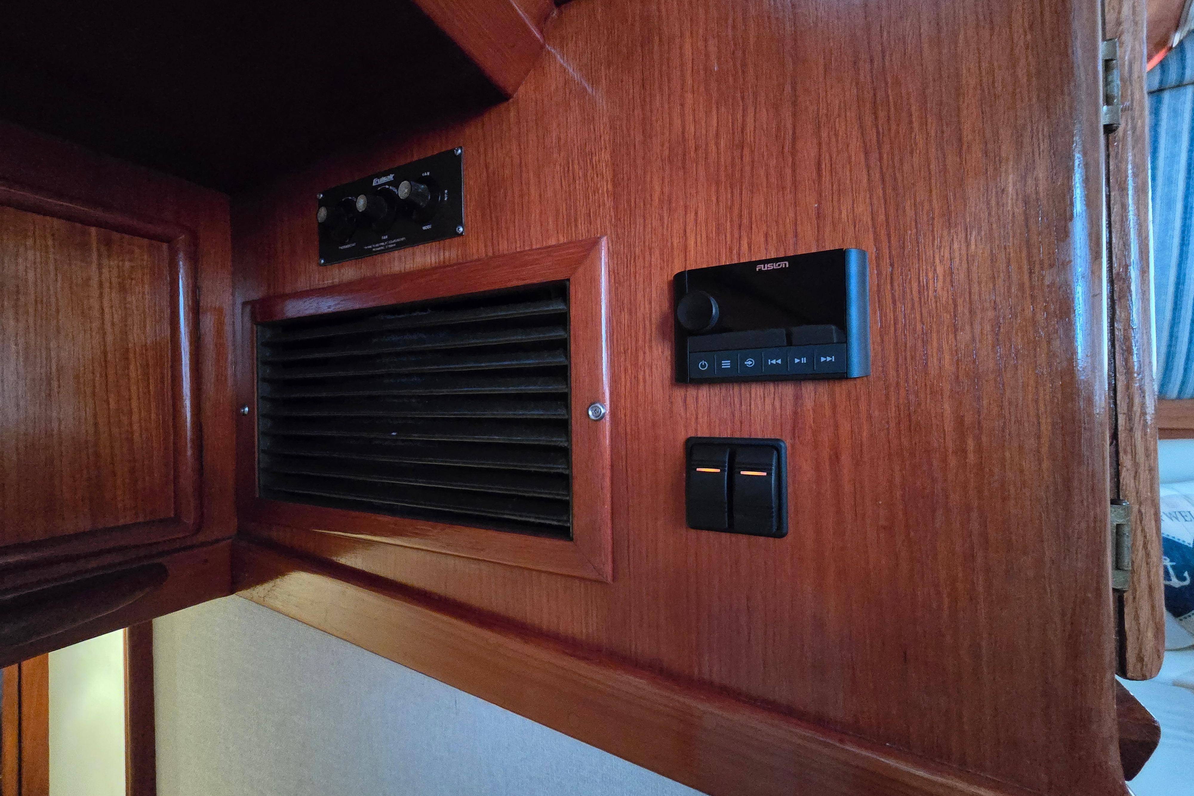 1988 Post 46 Convertible interior with wooden paneling, control switches, and audio system.