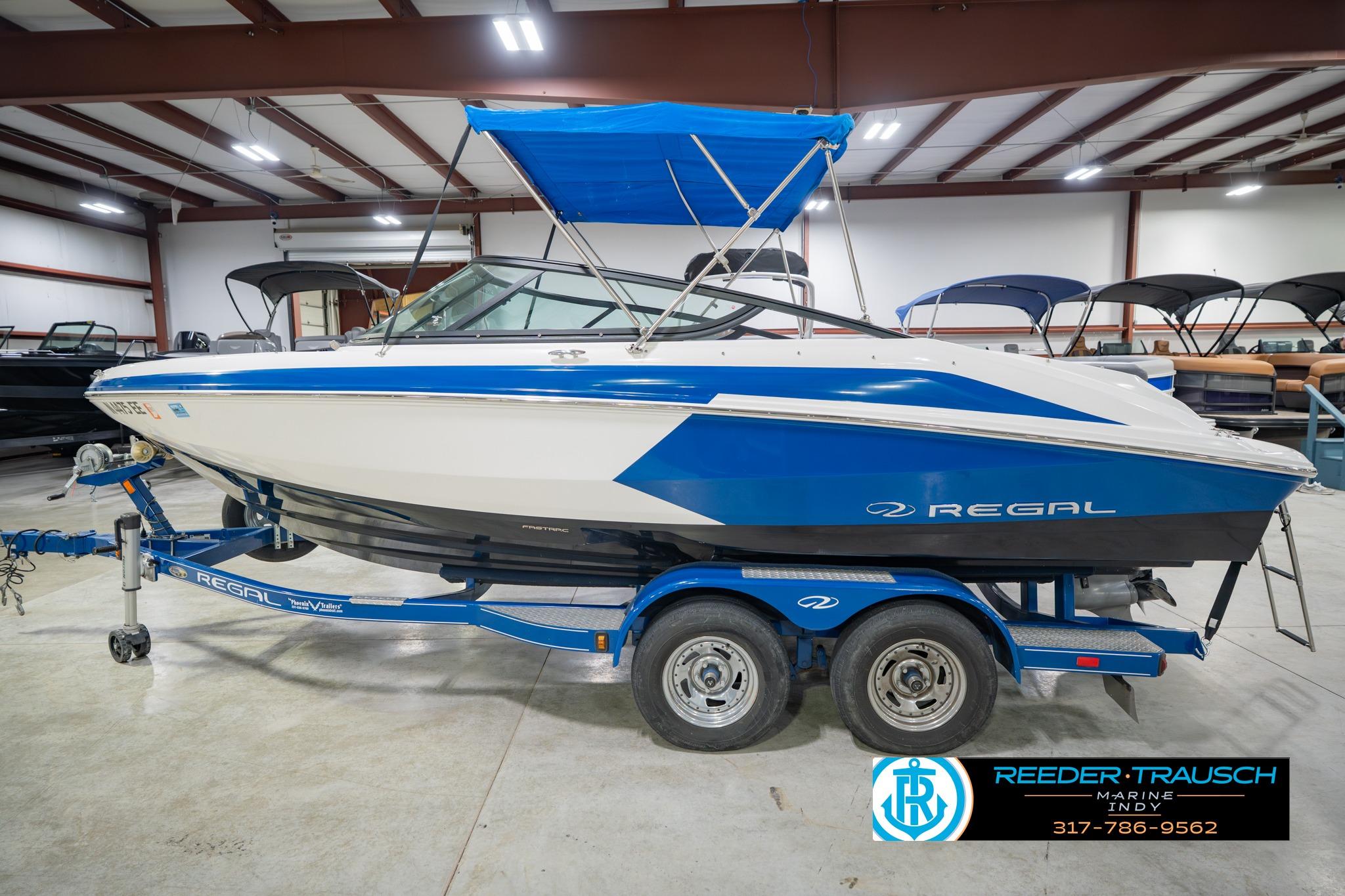 2015 Regal 2000 ESX Bowrider boat in showroom, blue and white design, on trailer.