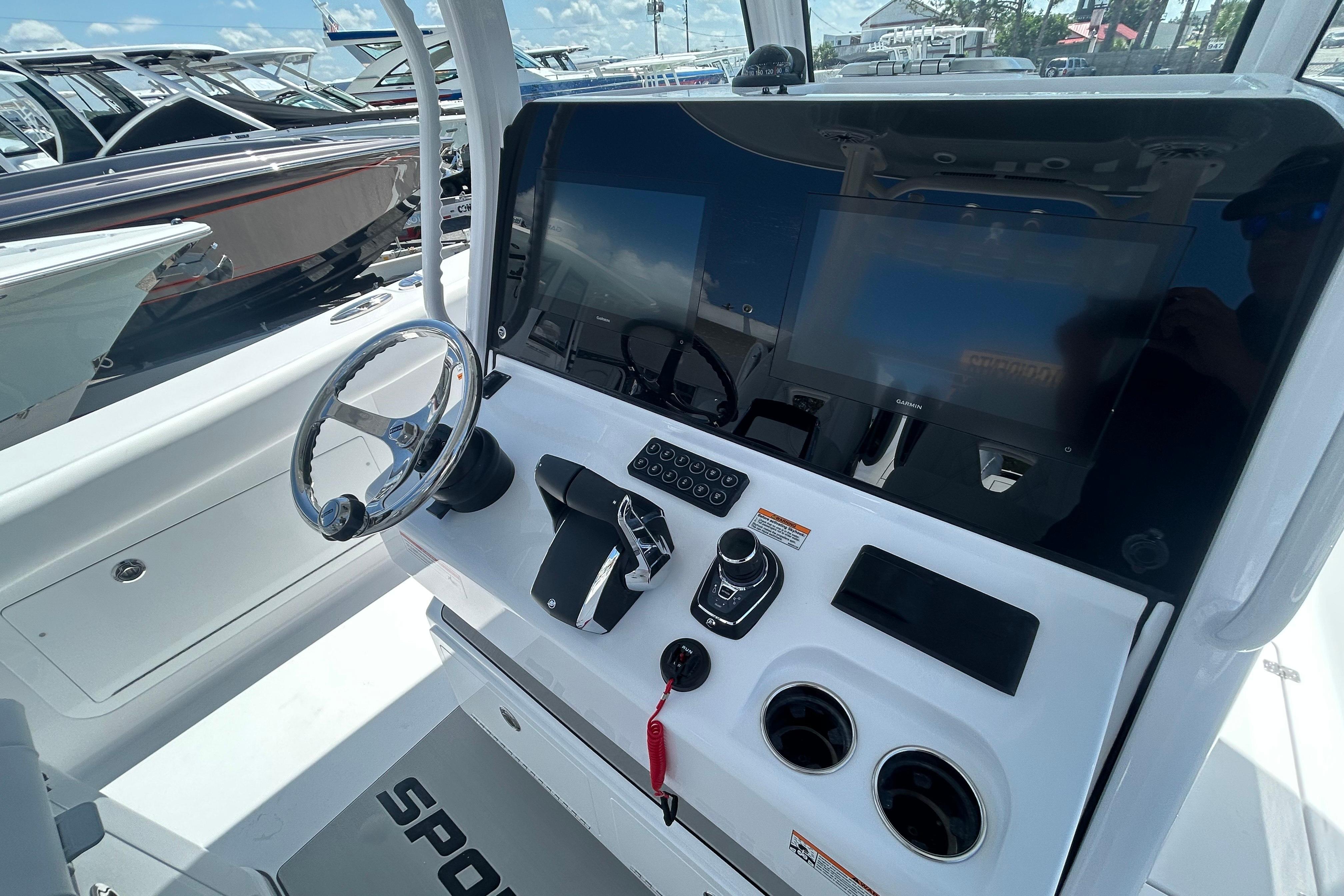 2026 Sportsman Heritage 321 Center Console boat dashboard with steering wheel and controls.