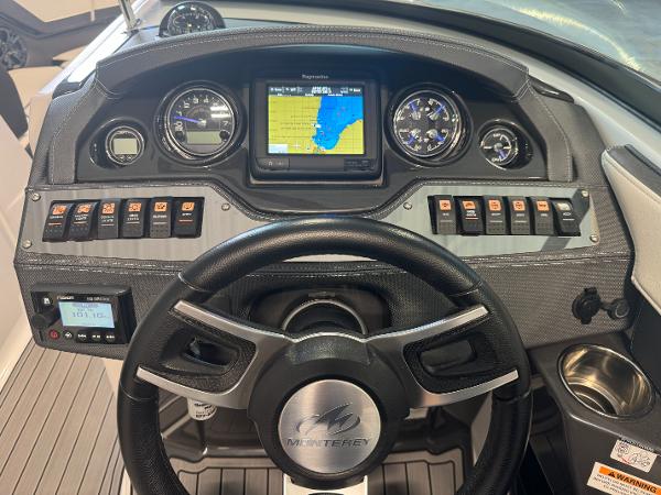 Dashboard of a 2018 Monterey 258 Super Sport boat with navigation display and controls.